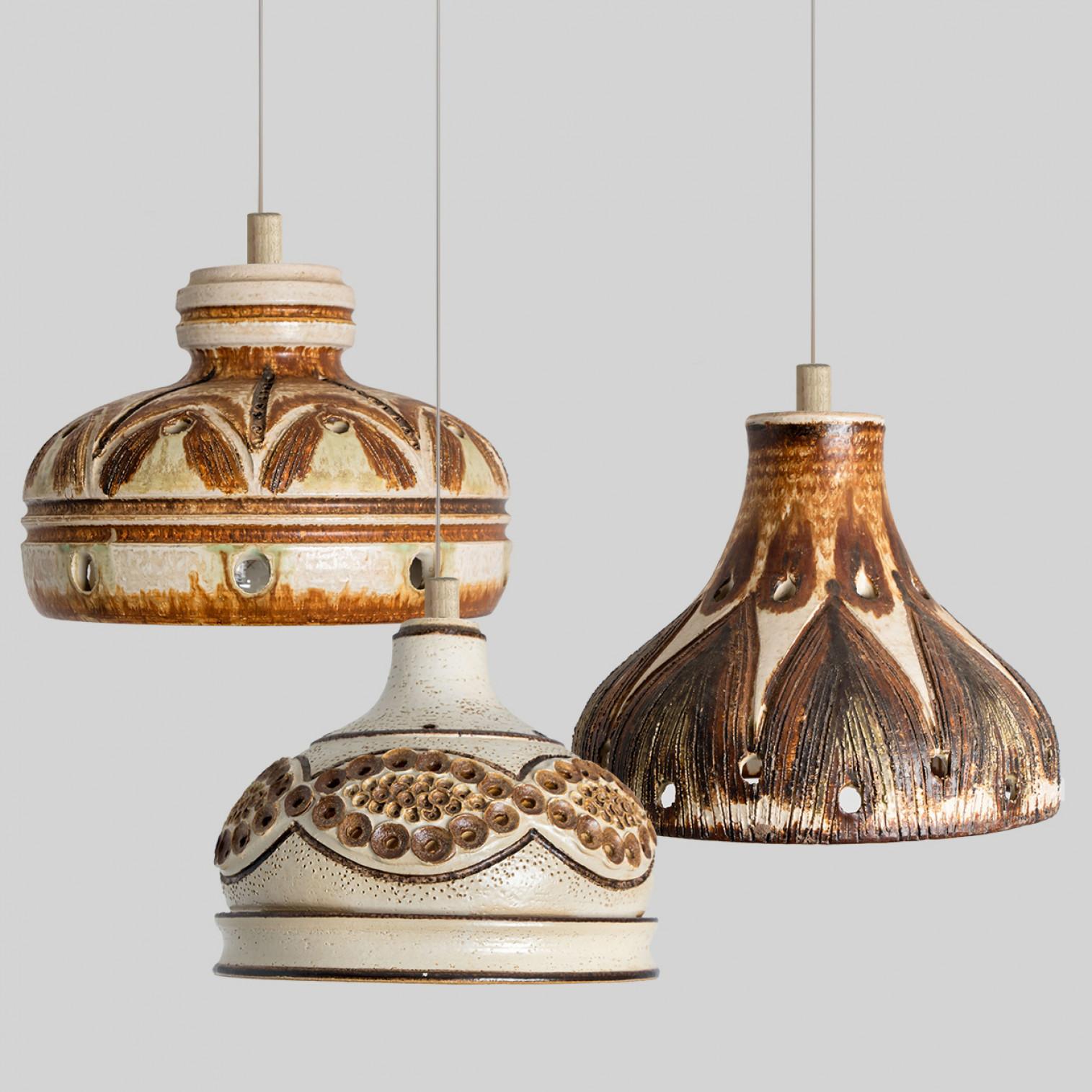 Playful arrangement of stunning round hanging lamps with an unusual shape, made with rich brown colored brown ceramics, manufactured in the 1970s in Denmark. We have a multitude of unique colored ceramic light sets and arrangements, all available in