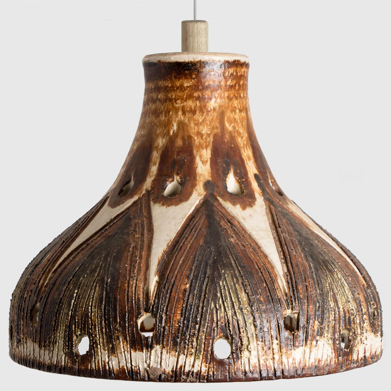 Playful arrangement of stunning round hanging lamps with an unusual shape, made with rich brown colored brown ceramics, manufactured in the 1970s in Denmark. We have a multitude of unique colored ceramic light sets and arrangements, all available in