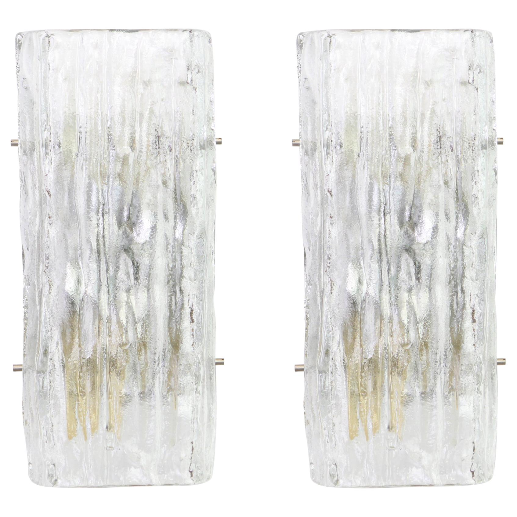 Wonderful pair of midcentury wall sconces with ice glass, made by Kalmar, Austria, manufactured, circa 1960-1969.
High quality and in very good condition. Cleaned, well-wired and ready to use.  

The fixture requires 2 x E14 standard bulbs with