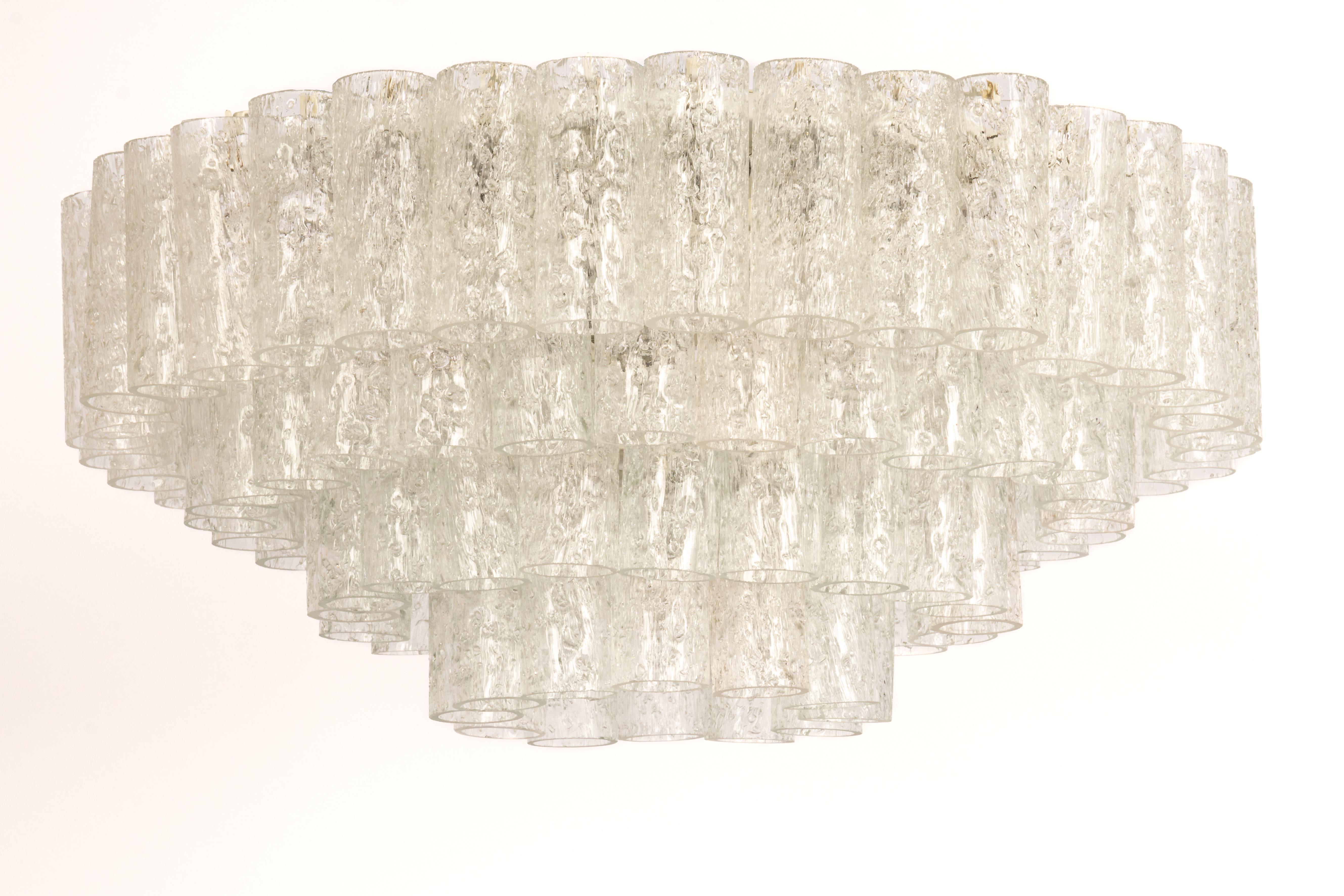 Fantastic four-tier midcentury chandelier by Doria, Germany, manufactured circa 1960-1969. 4 rings of Murano glass cylinders suspended from a fixture.

Sockets: 10 x E14 candelabra bulbs (up to 40 W each) .
Light bulbs are not included. It is