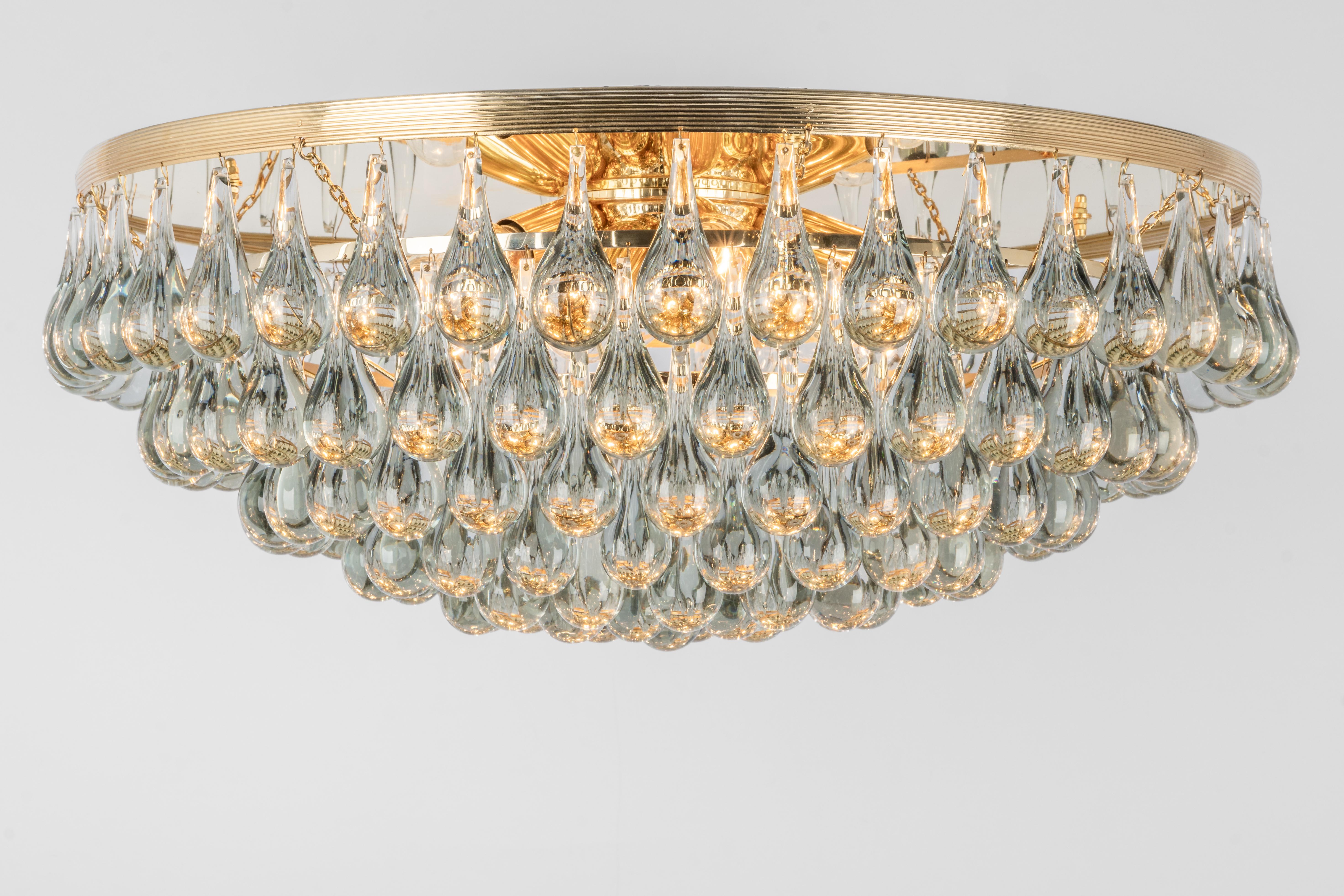 A stunning huge chandelier by Christoph Palme, Germany, was manufactured in the 1970s. It’s composed of Murano teardrop glass pieces on a metal /brass frame.
High quality of materials.
3 items are available.
Sockets: It needs 12 x E14 base bulbs to