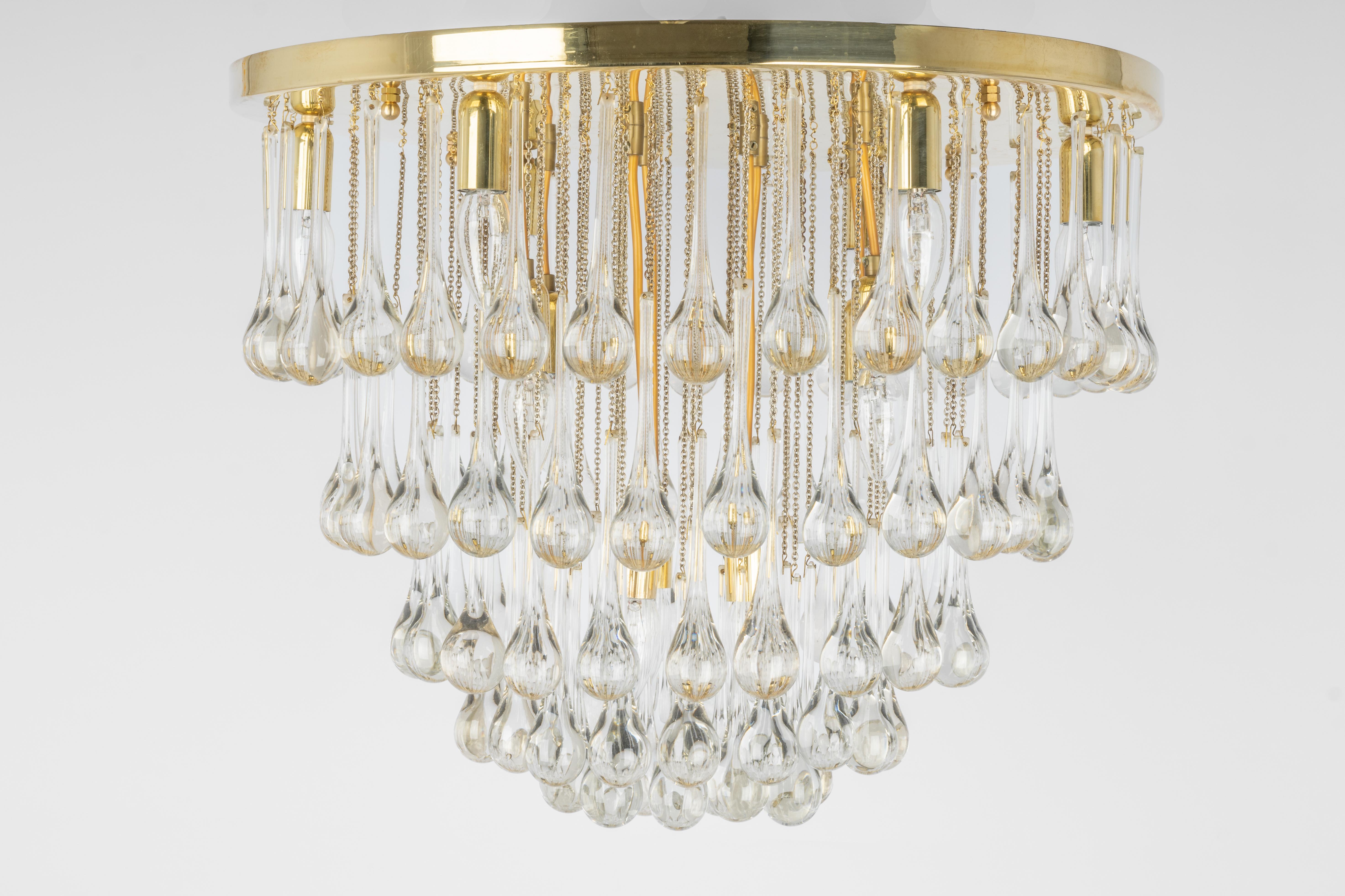 Stunning chandelier by Christoph Palme, Germany, manufactured in the 1970s. It’s composed of Murano teardrop glass pieces on a brass frame.
Wonderful light effect.
High quality and in good condition. Cleaned, well-wired, and ready to use. 

Each