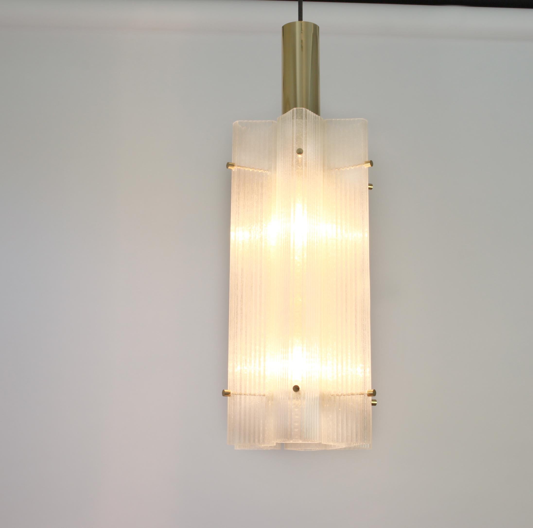 1 of 3 large Murano ice glass pendants by Limburg, Germany, 1970s.

6 glass elements on a brass frame with 2 x E27 standard bulbs.
 Light bulbs are not included. It is possible to install this fixture in all countries (US, UK, Europe, Asia,