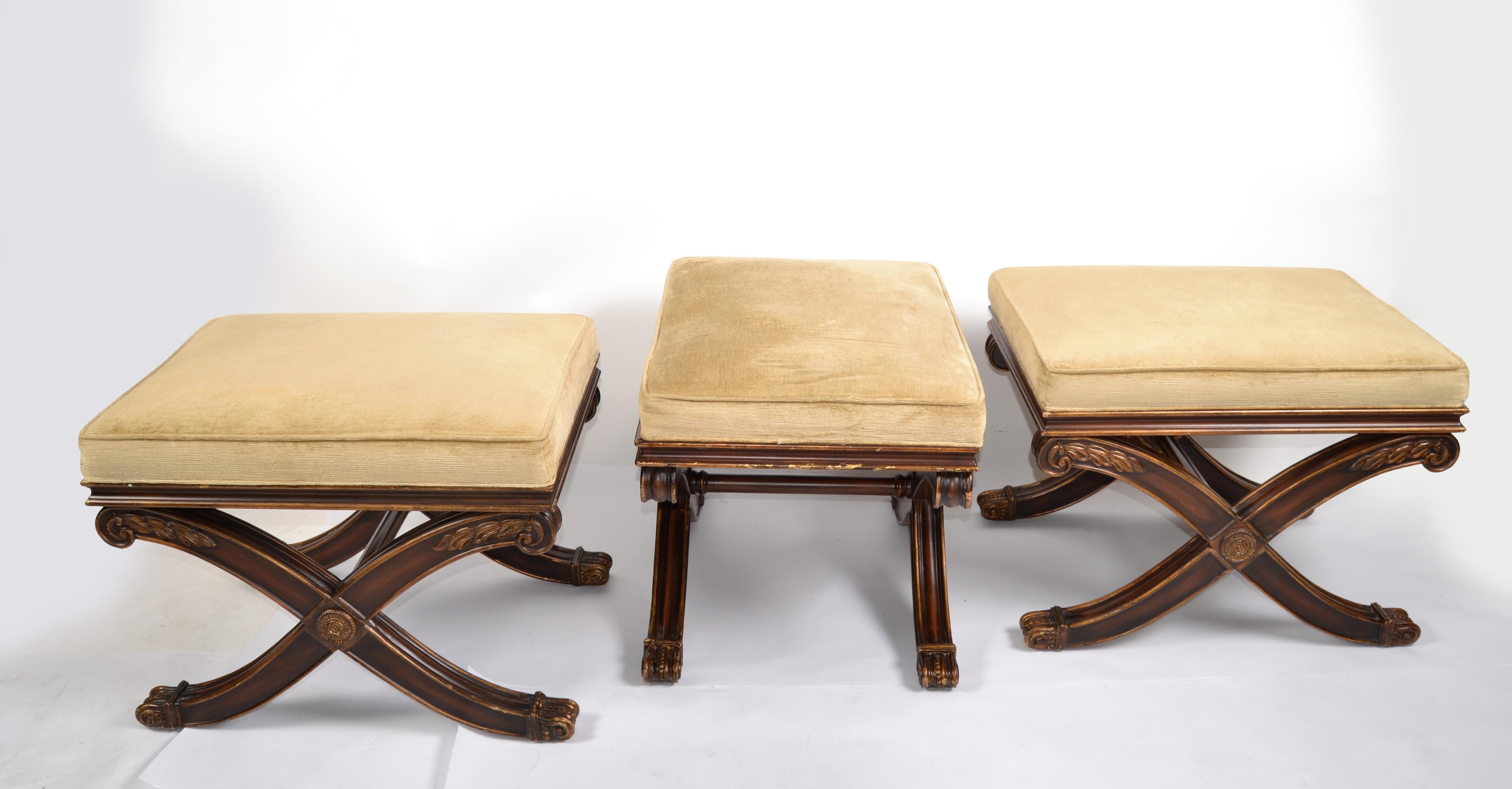 Three beautiful French Neoclassical Hollywood Regency style benches, stools or ottoman with an X-base.
The upholstered seats are in a mustard cord fabric and look great. The base has gilded highlights and carved wooden appliques. This set of 3