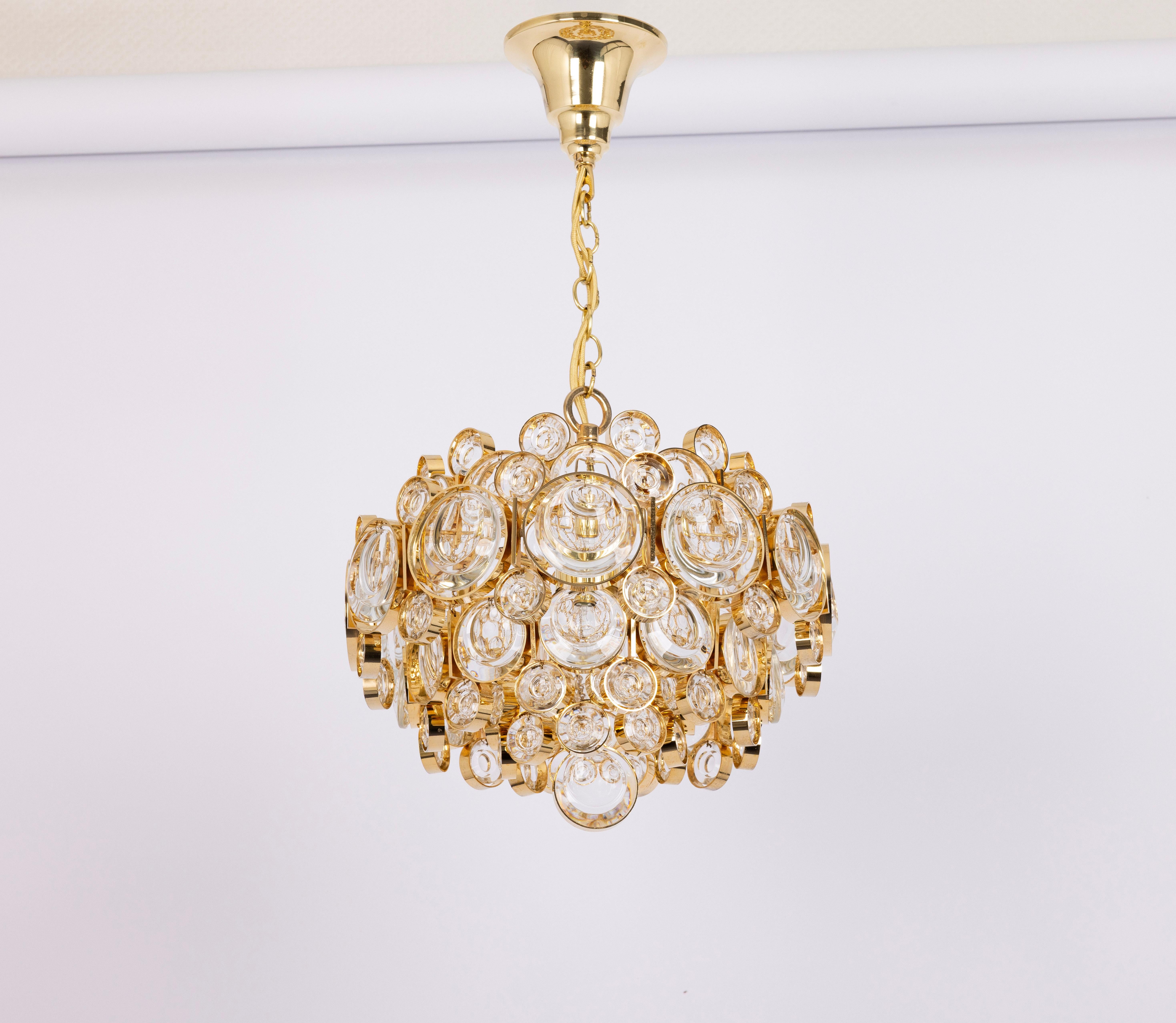 A wonderful and high-quality gilded chandelier or pendant light fixture by Palwa -Design in style of  Sciolari, Germany, 1970s.
It is made of a 24-carat gold-plated brass frame decorated with individual 