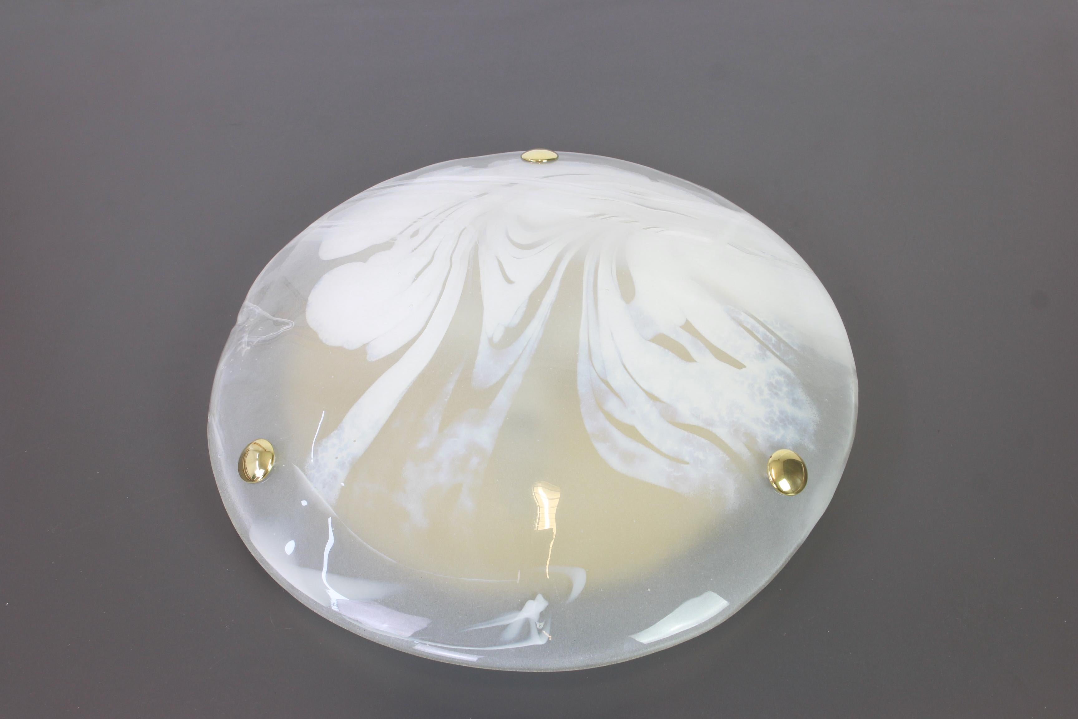 A wonderful round Murano glass flush mount by Hillebrand Leuchten, Germany, 1970s.
Thick Murano glass fixtured on a brass metal base with three brass screws.

High quality and in perfect condition. Cleaned, well-wired and ready to use. 

The