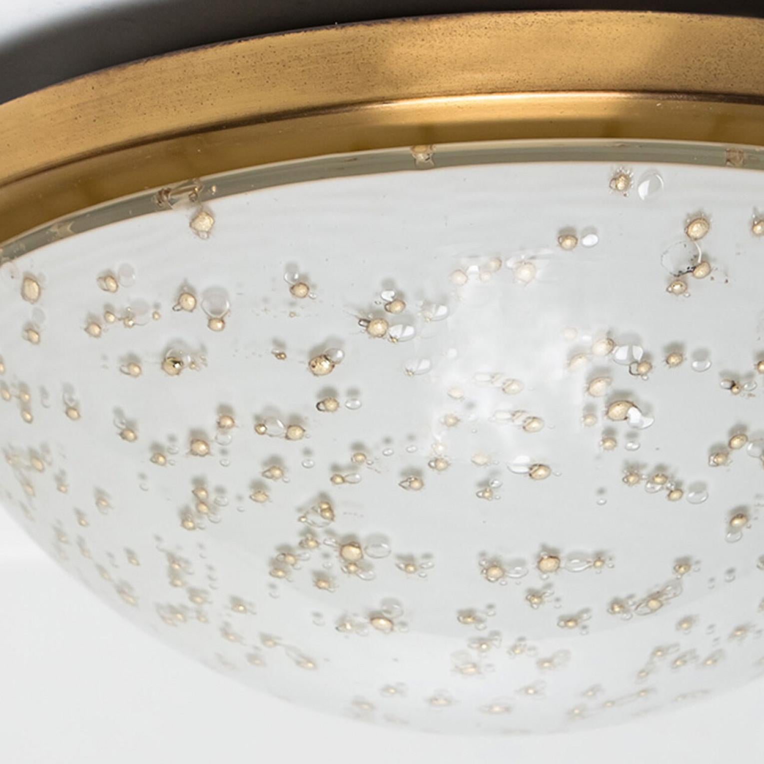 Two beautiful mid-20th century flush mounts by Peill & Putzler. Made around 1970 in Germany, Europe. Featuring a large milk glass shade with gold speckles in the middle. The light illuminates wonderful.

The lights can also be used as wall