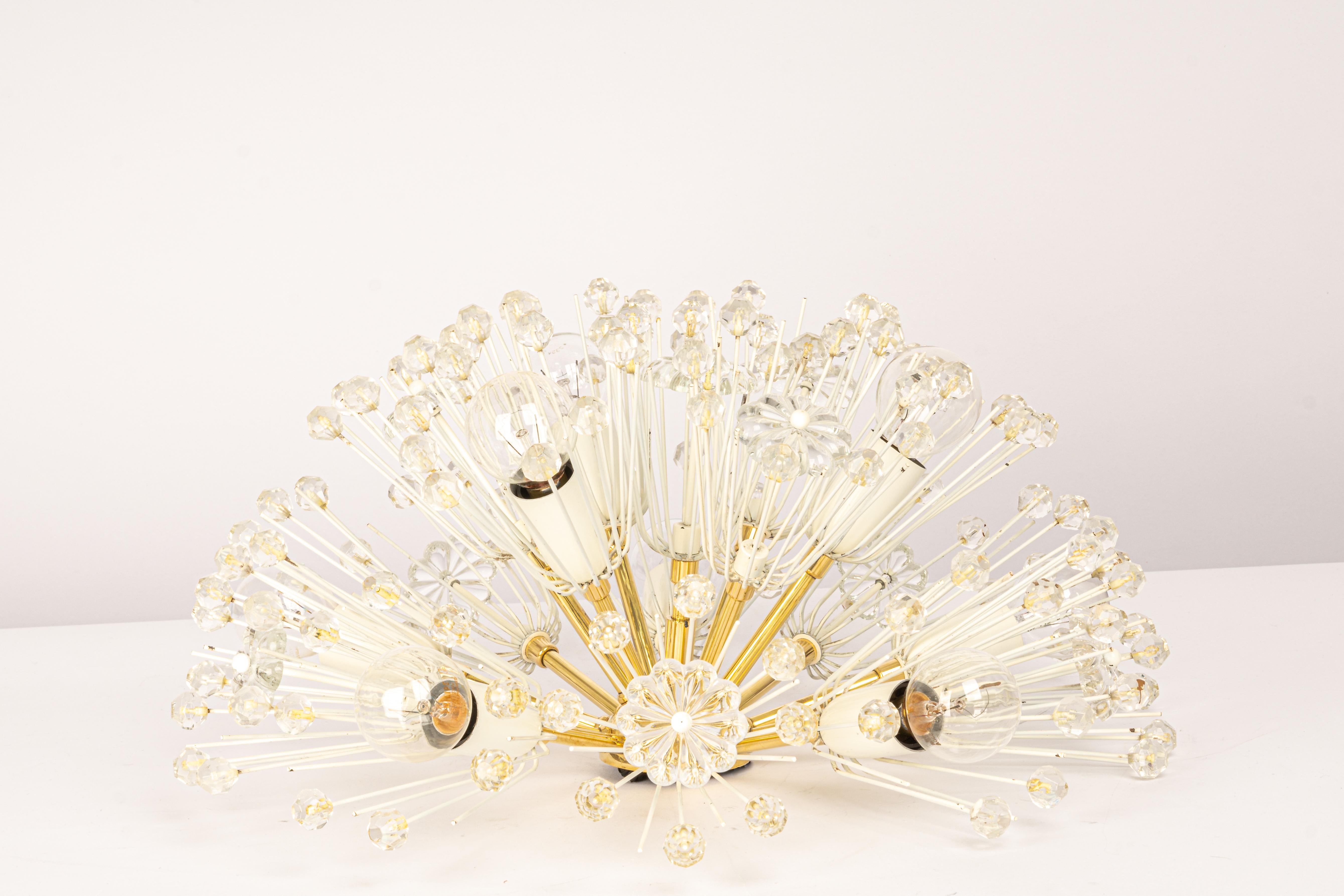 Beautiful large starburst brass flush mount with hundreds of crystals designed by Emil Stejnar for Nikoll, manufactured in Austria, circa the 1960s.

Heavy quality and in good condition with small signs of age.
Cleaned, well-wired and ready to