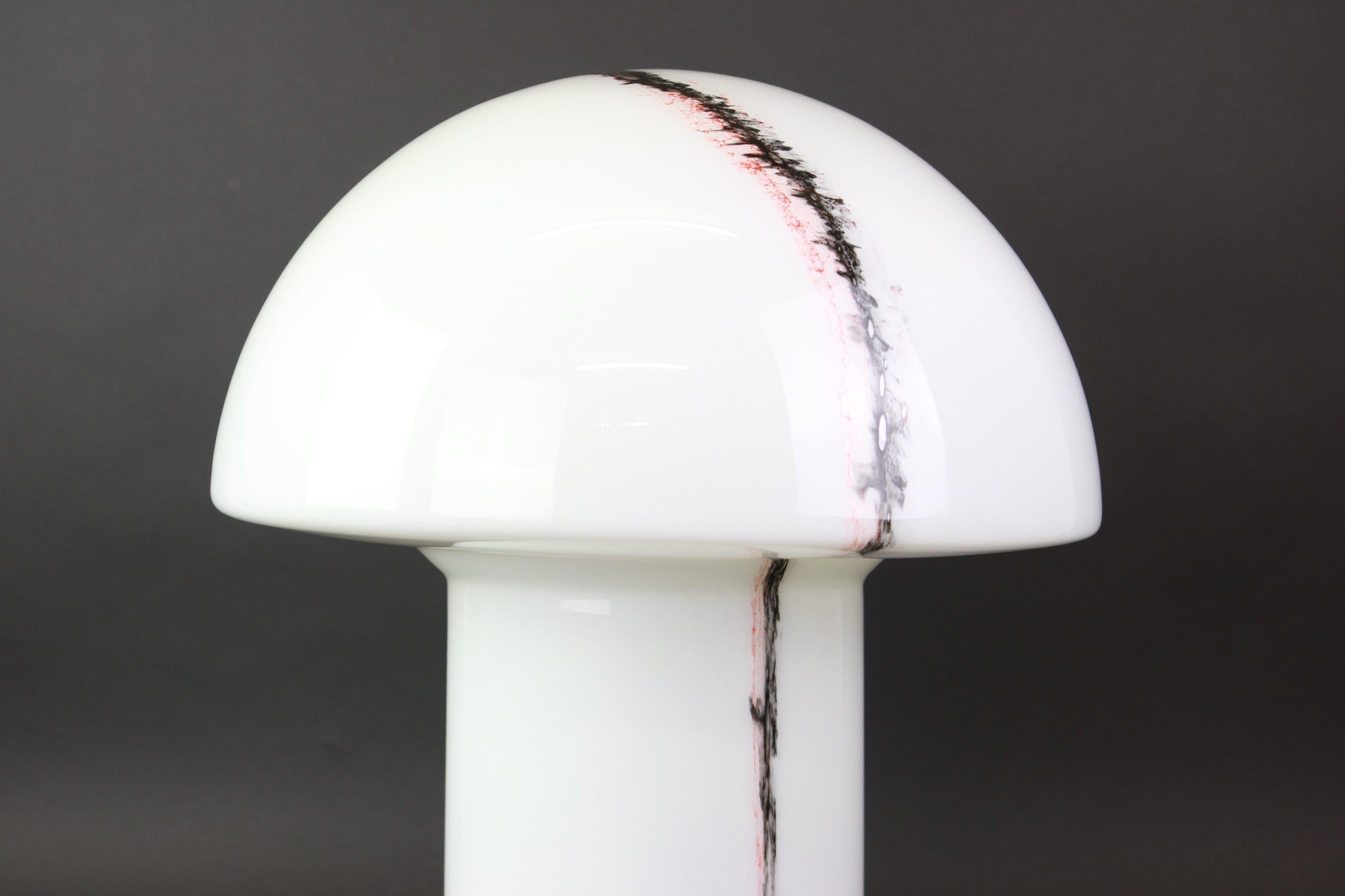 1 of 2 Wonderful extra-large midcentury mushroom table lamp by Peill & Putzler, Germany, 1970s.
Made of a single piece of blown and cased glass with black and red pigment inclusions which have been applied in an abstract expressionist manner.
This