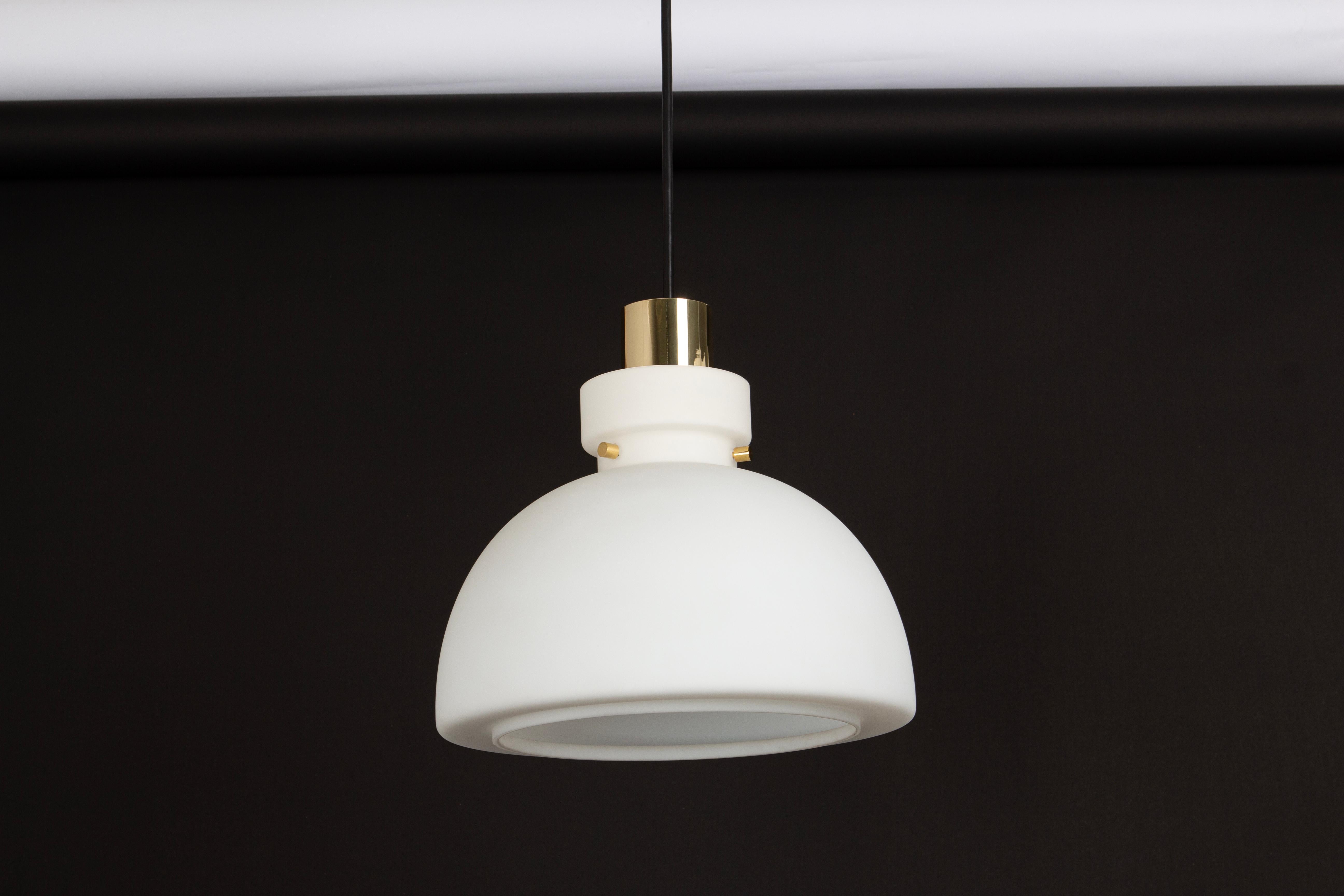 Stunning opal glass pendants in a pyramided form made by Limburg, Germany, 1970s
High quality and in very good condition. Cleaned, well-wired and ready to use. 

Each fixture requires one standard bulb.
Light bulbs are not included. It is possible