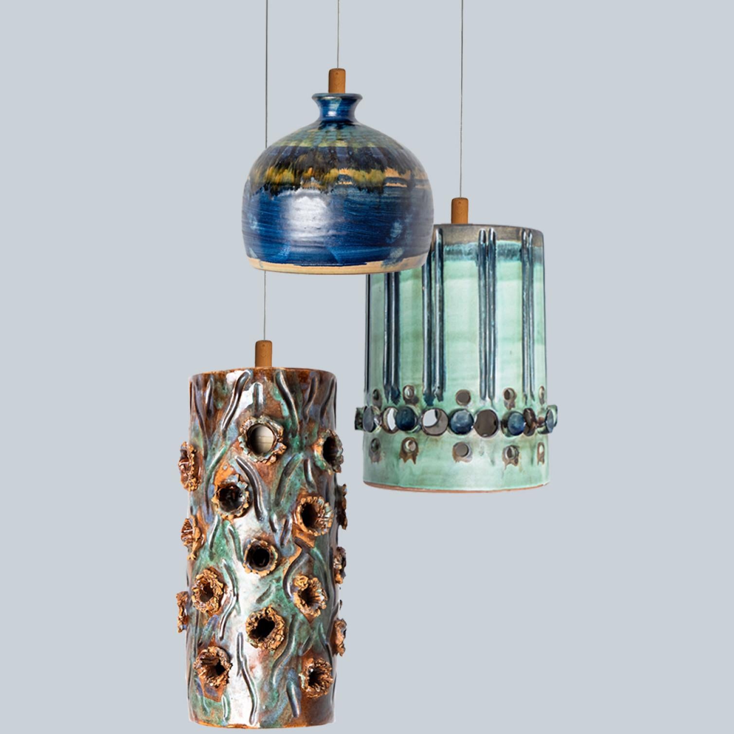 Playful arrangement of stunning round hanging lamps with an unusual shape, made with rich turquoise colored brown and blue ceramics, manufactured in the 1970s in Denmark. We have a multitude of unique colored ceramic light sets and arrangements, all