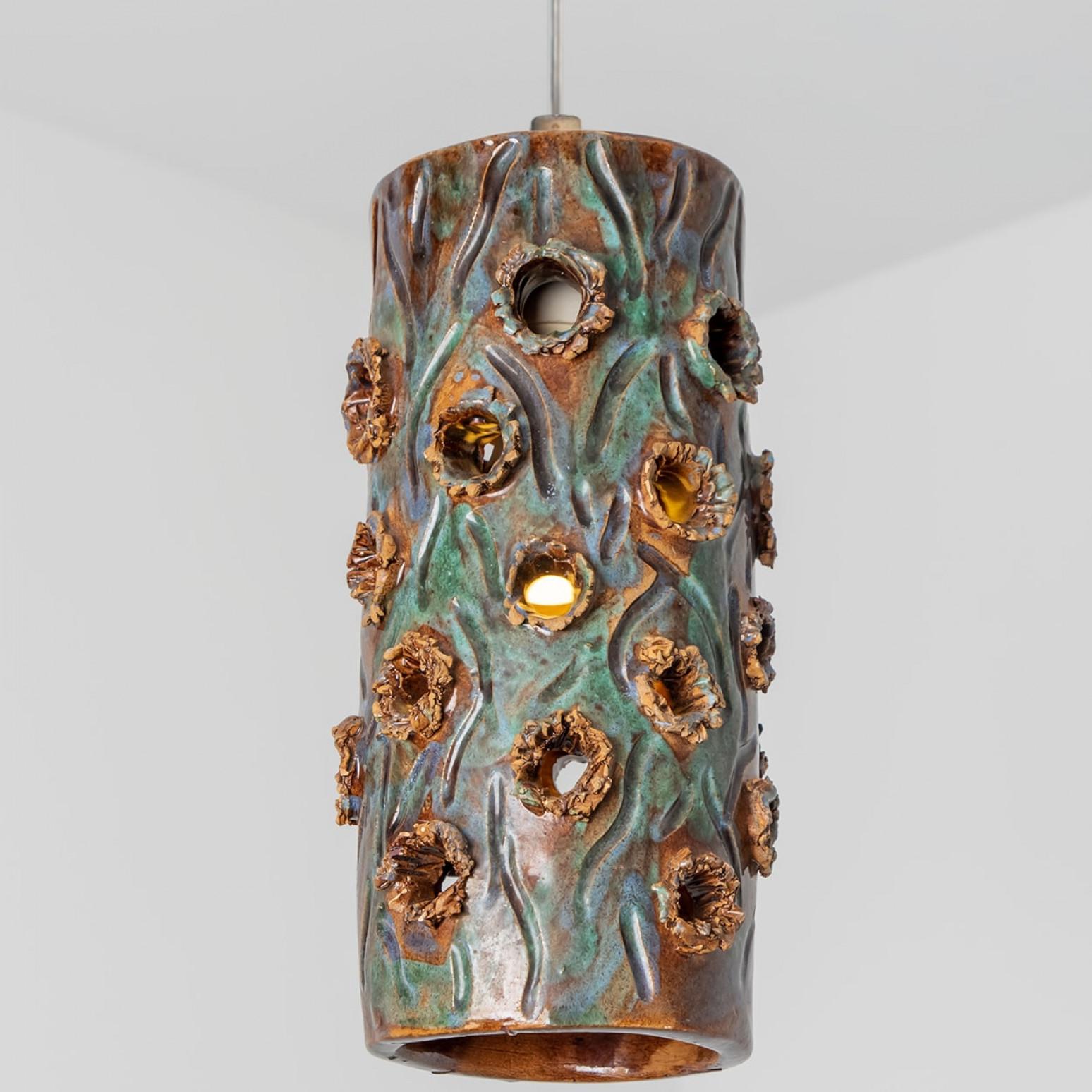Playful arrangement of stunning round hanging lamps with an unusual shape, made with rich turquoise colored brown and blue ceramics, manufactured in the 1970s in Denmark. We have a multitude of unique colored ceramic light sets and arrangements, all