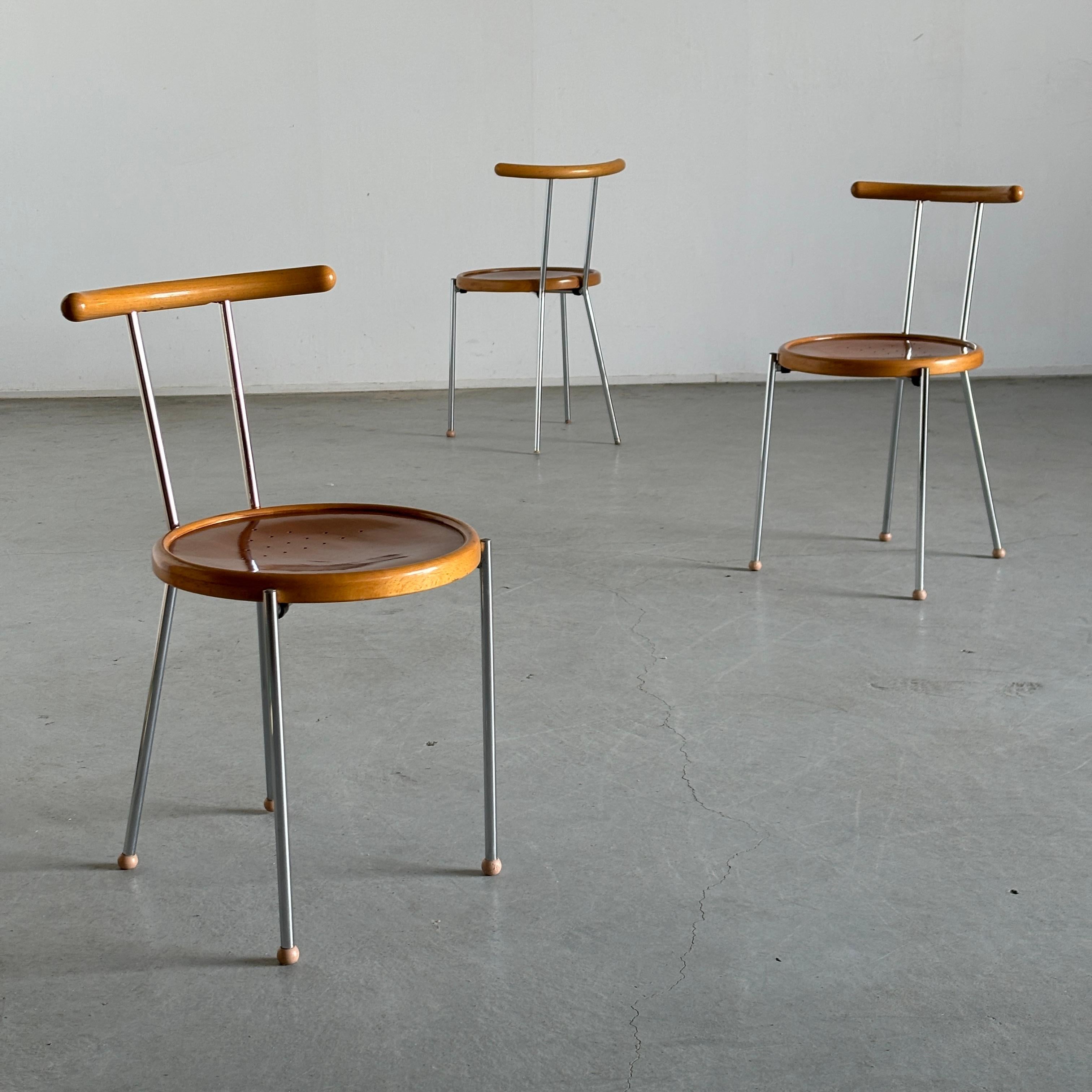 Vintage postmodern dining chairs featuring circular wooden seats and backrests on a chromed steel frame with rounded rubber floorstops.
Produced in Italy in the 1970s.

Price refers to a single piece.
Two available.

In good vintage condition, with