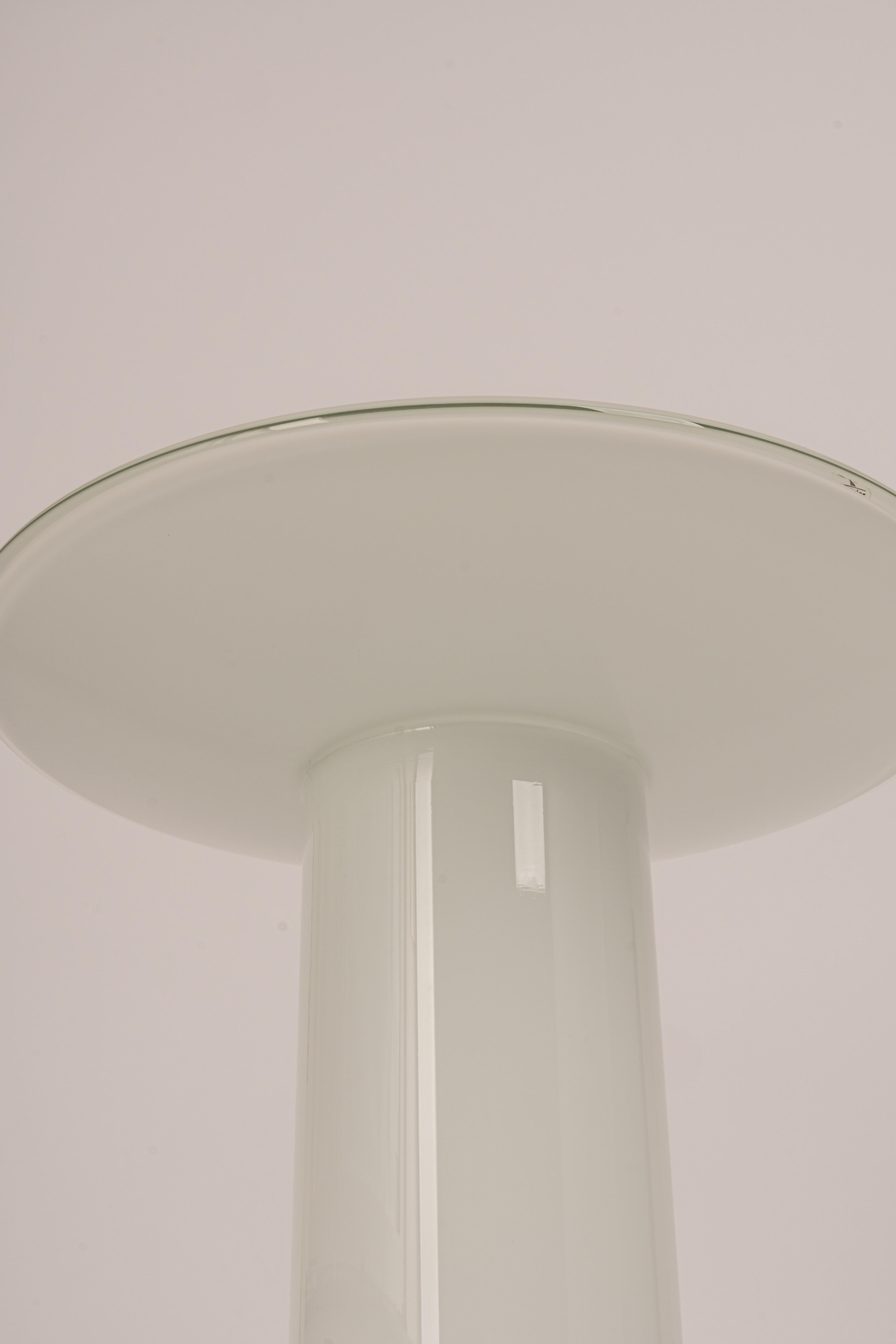 Wonderful mushroom table lamp by Peill & Putzler, Germany, 1970s. Made of a single piece.
Great glass body and its edgy quality contrast nicely with the smooth surface and shape of the mushroom. 

Measures: Large table lamp
Height 27 cm // 10.6