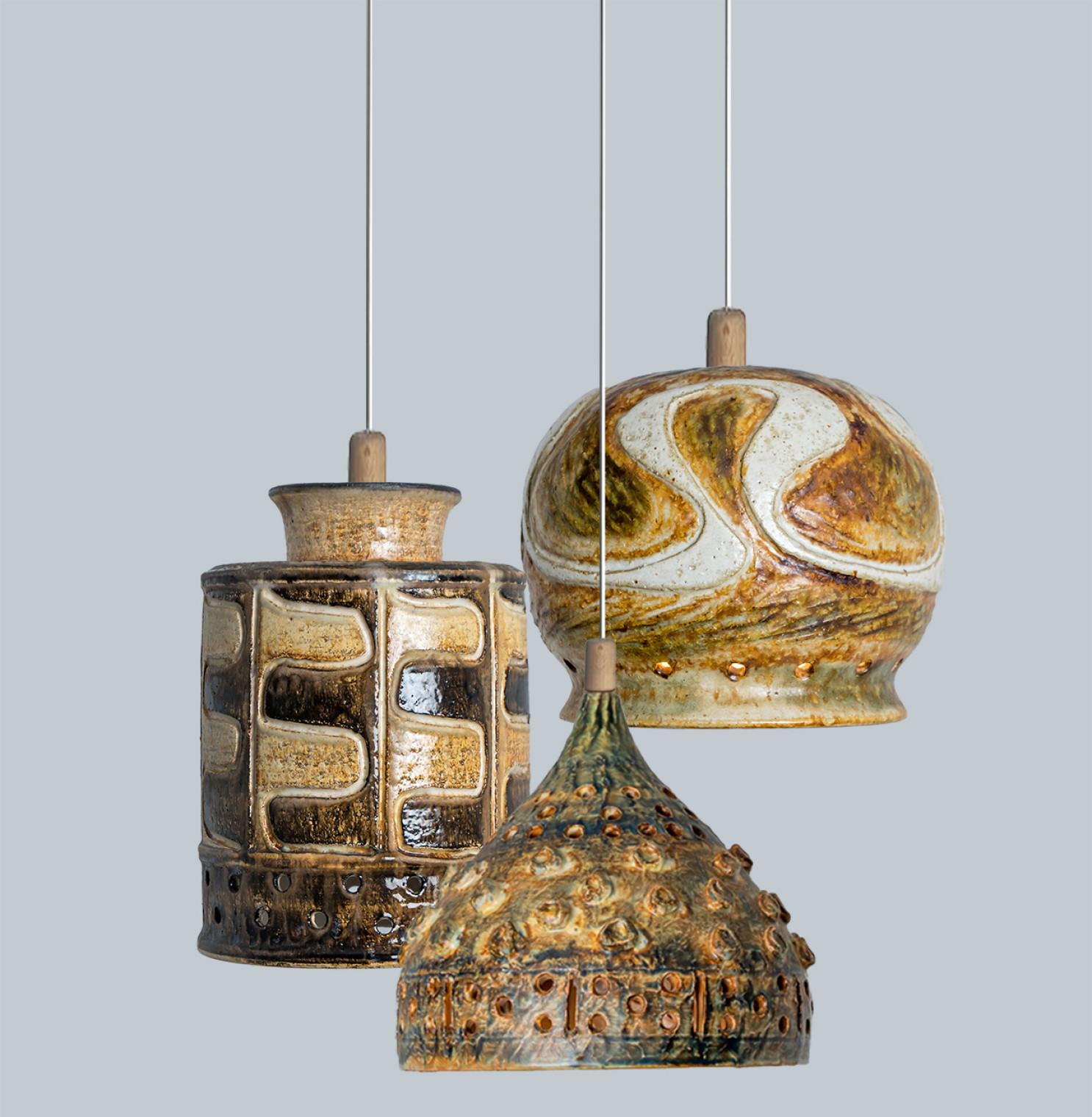Playful arrangement of stunning round hanging lamps with an unusual shape, made with rich light colored brown ceramics, manufactured in the 1970s in Denmark. We have a multitude of unique colored ceramic light sets and arrangements, all available in