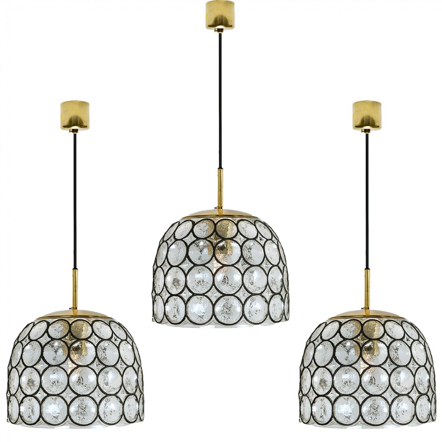 Minimal, geometric and simply shaped design. This beautiful and unique pair of hand blown glass chandeliers/pedant lights were manufactured by Glashütte Limburg in Germany during the 1960s (late 1960s or early 1970s). Beautiful craftsmanship. These