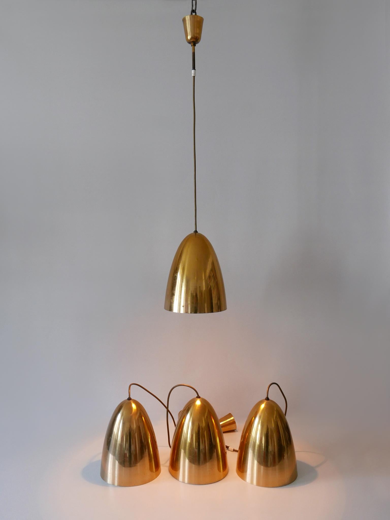 Elegant and highly decorative Mid-Century Modern pendant lamps or hanging lights. Designed & manufactured in Germany, 1950s.

Price per item. Four identical pendant lamps available

Executed in gilt / gold anodized aluminium, each pendant lamp is