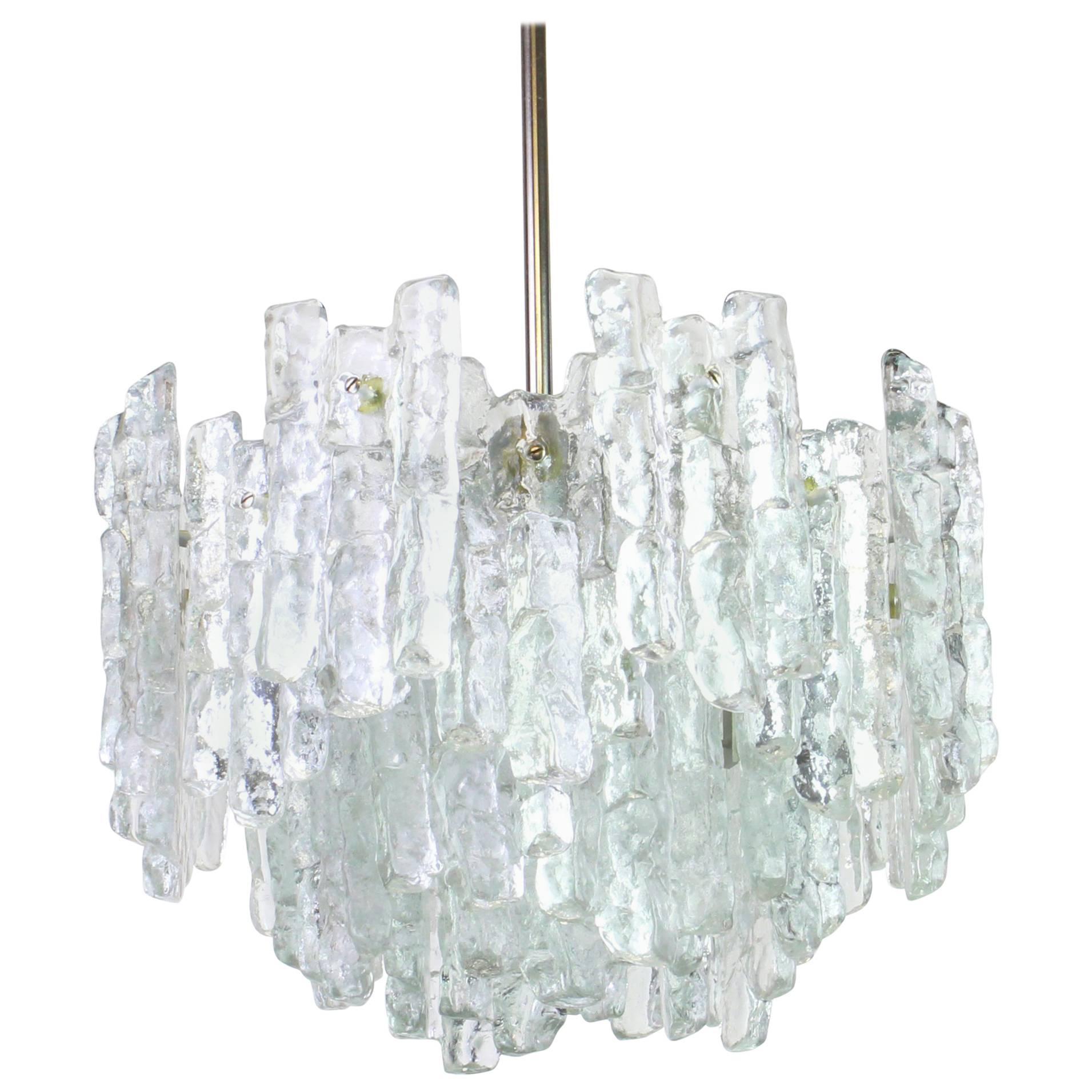 Stunning Murano glass chandelier by Kalmar, 1960s
Three tiers structure gathering 28 structured glasses, beautifully refracting the light very heavy quality.
High quality and in very good condition. Cleaned, well-wired and ready to use. 
The