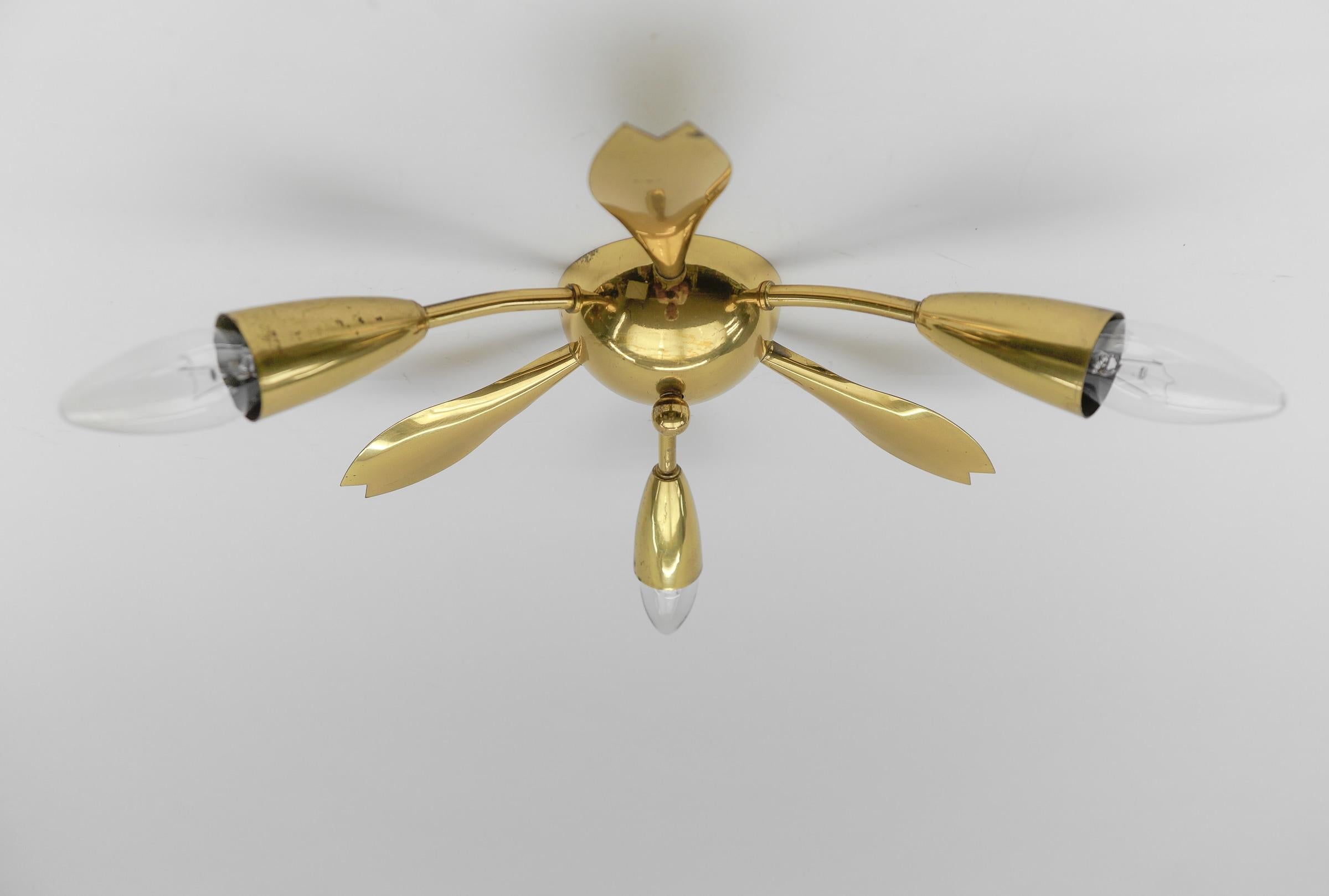 Midcentury 3-armed brass ceiling lamp. In the manner of Arteluce.

Rare and elegant midcentury ceiling lamp, 1950s. Executed in brass and metal.

The lamp is executed with 3 x E14 Edison screw fit bulbs. It is wired and in working condition. It runs