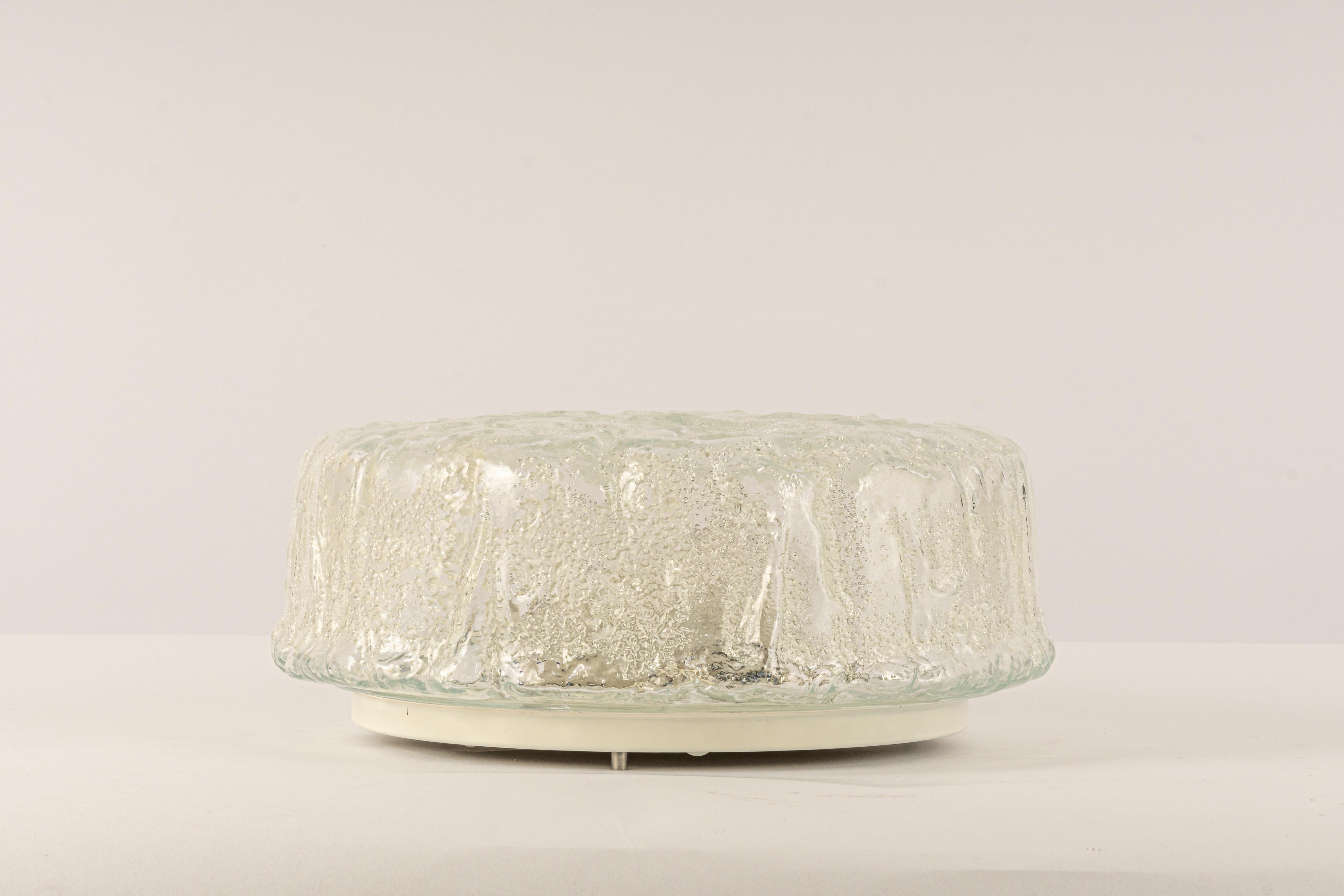 A wonderful round Murano glass flush mount by Limburg, Germany, 1970s.
Thick textured Murano fixtured on a white metal base.

High quality and in very good condition. Cleaned, well-wired, and ready to use. 

Each fixture requires 2 x E27
