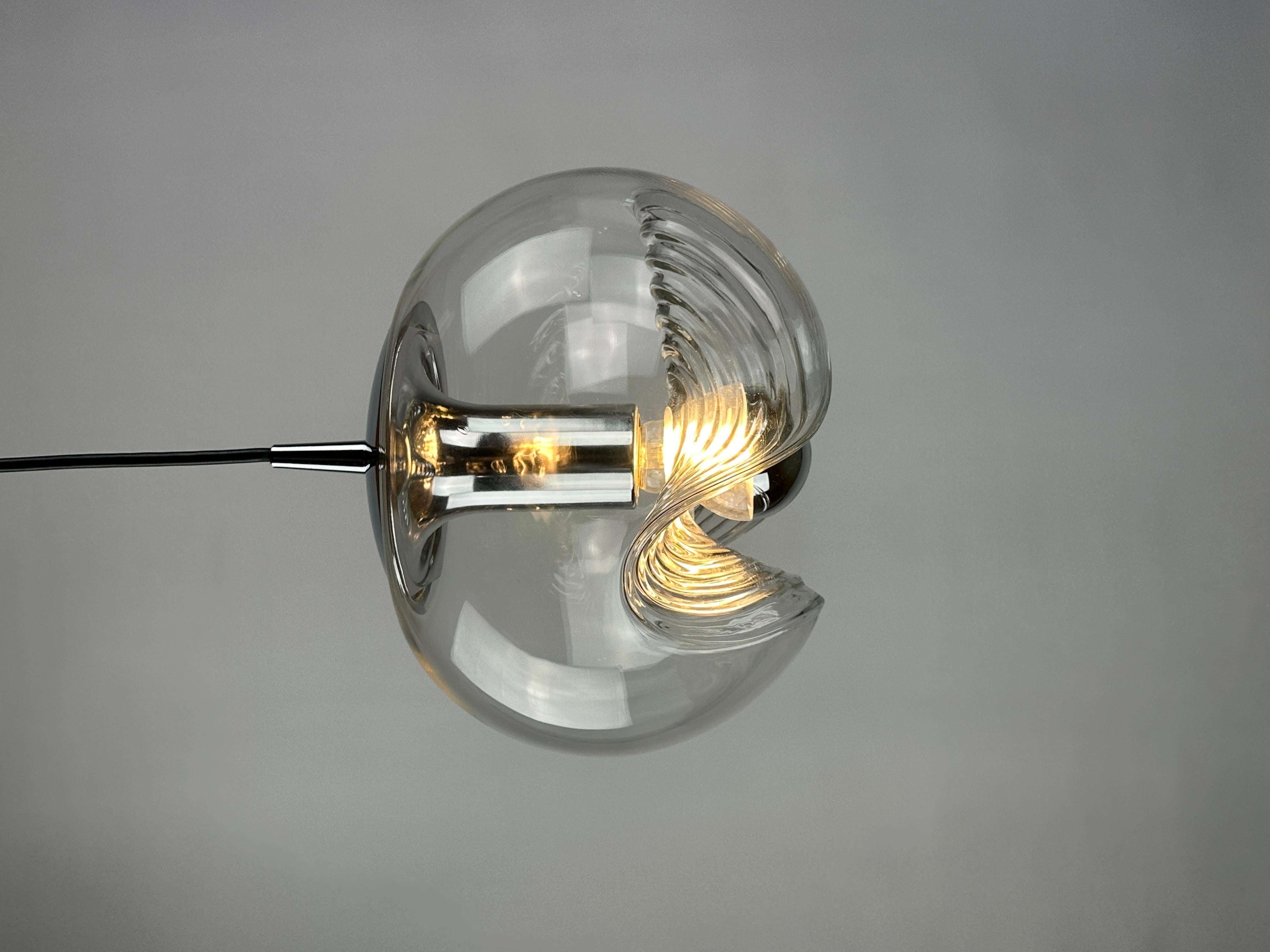Beautiful German pendant light manufactured by Peill and Putzler produced around 1970. Amazing wave shaped glass globe and chrome hanging element and a aluminium reflector inside the globe. This is the medium version.  

Has been rewarded with the