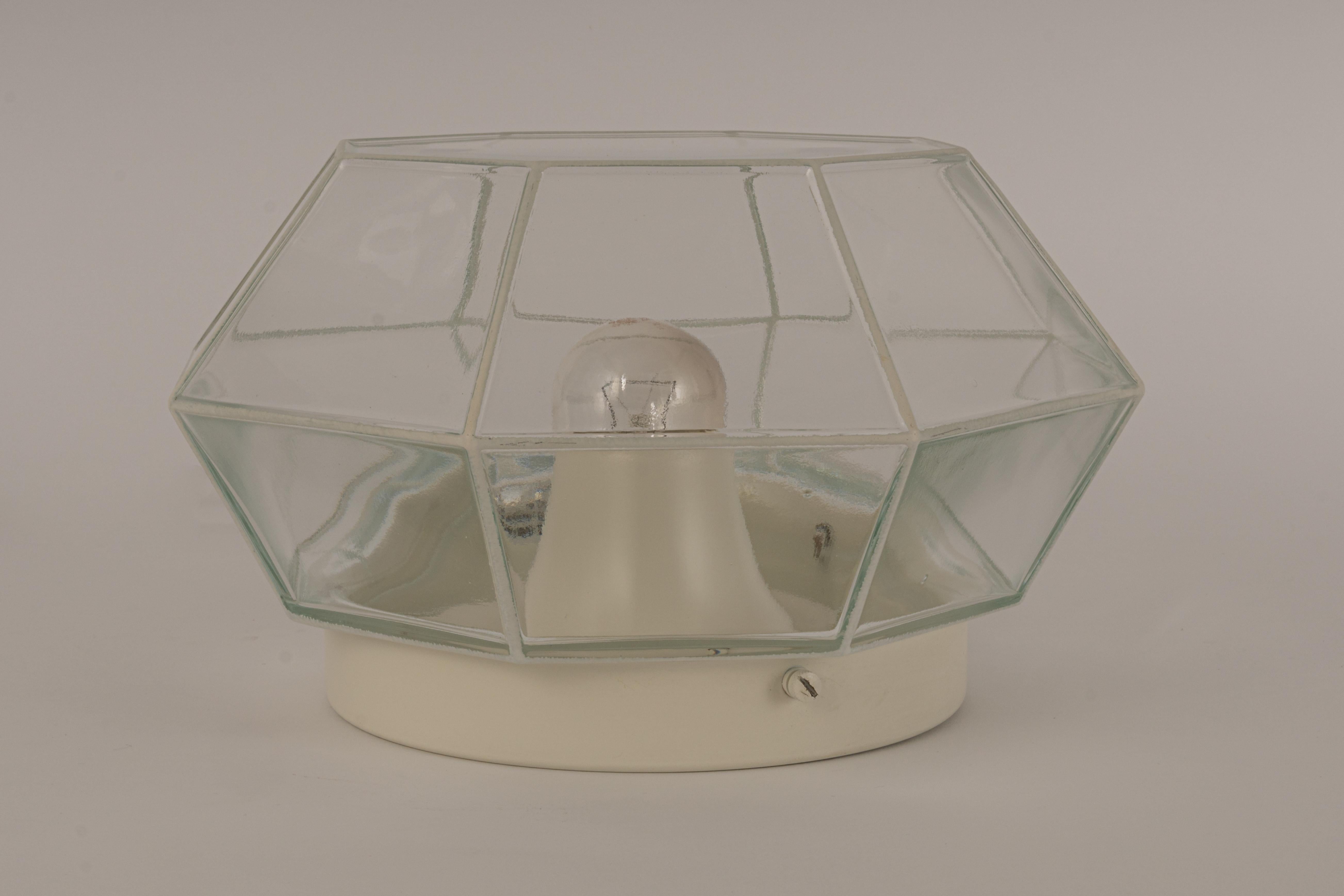 Minimalist iron and clear glass flush mount manufactured by Limburg Glashu¨tte Germany, circa 1960-1969. Octagonal shaped lantern and multifaceted clear glass.

Each light requires 1 x E27 Standard bulbs - max 60 watt 
Light bulbs are not