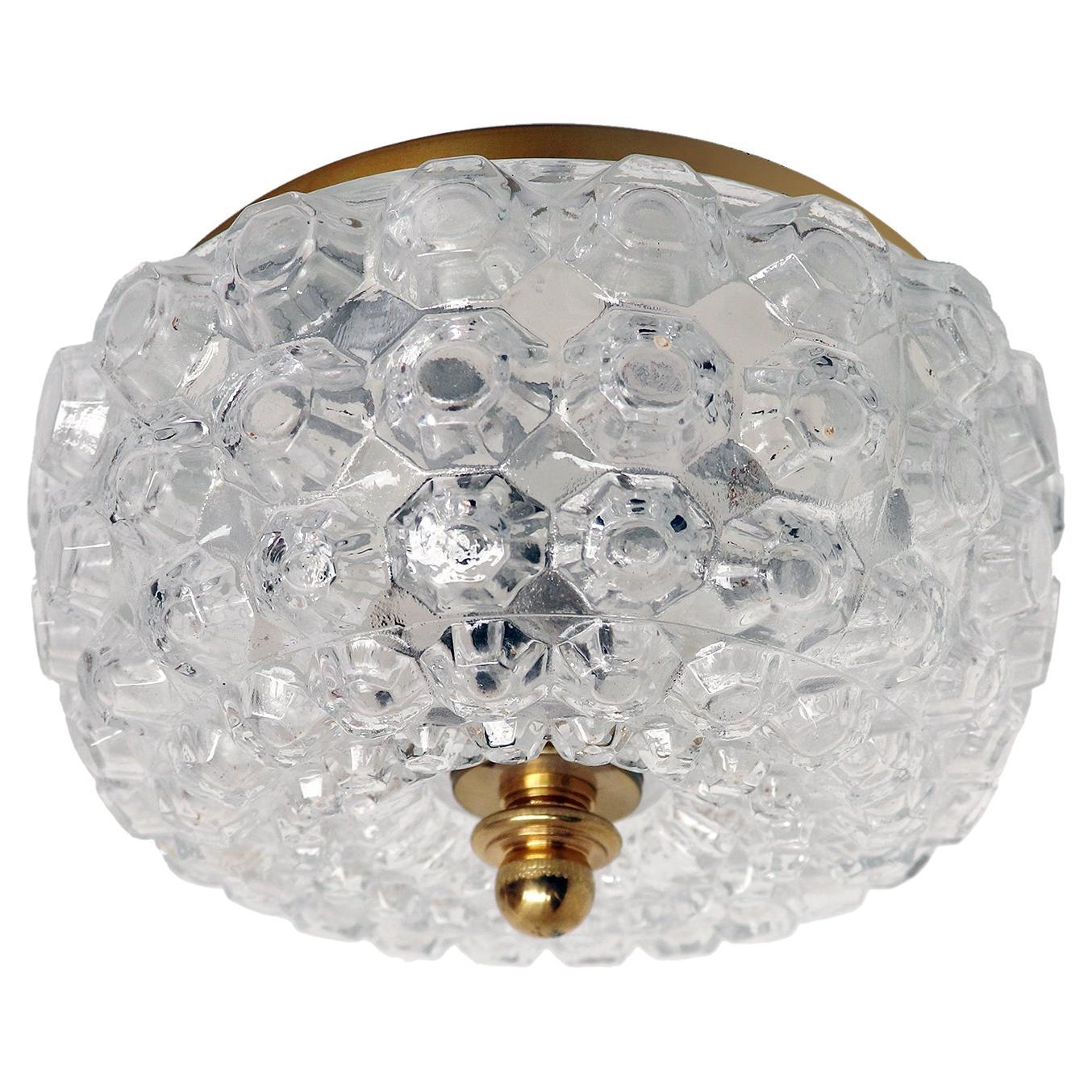 Elegant modernist flush mount ceiling light and wall sconce made of clear, thick and textured glass dome on a brass frame designed by Helena Tynell attr. Manufactured by Glashutte Limburg, Germany in the 1960s. 

Design: Helena Tynell attr. 
Style: