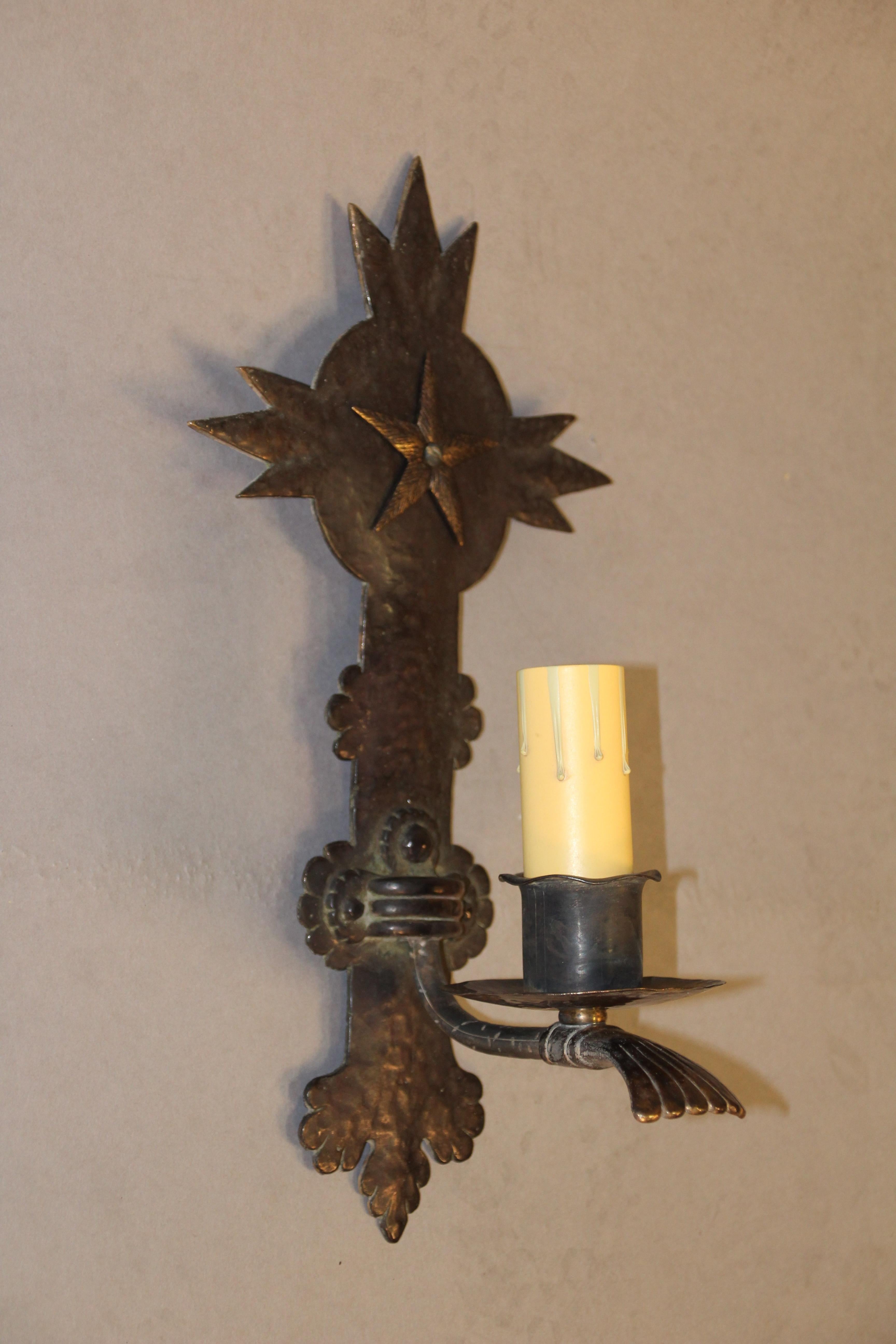 Circa 1920s sconce with star pattern.