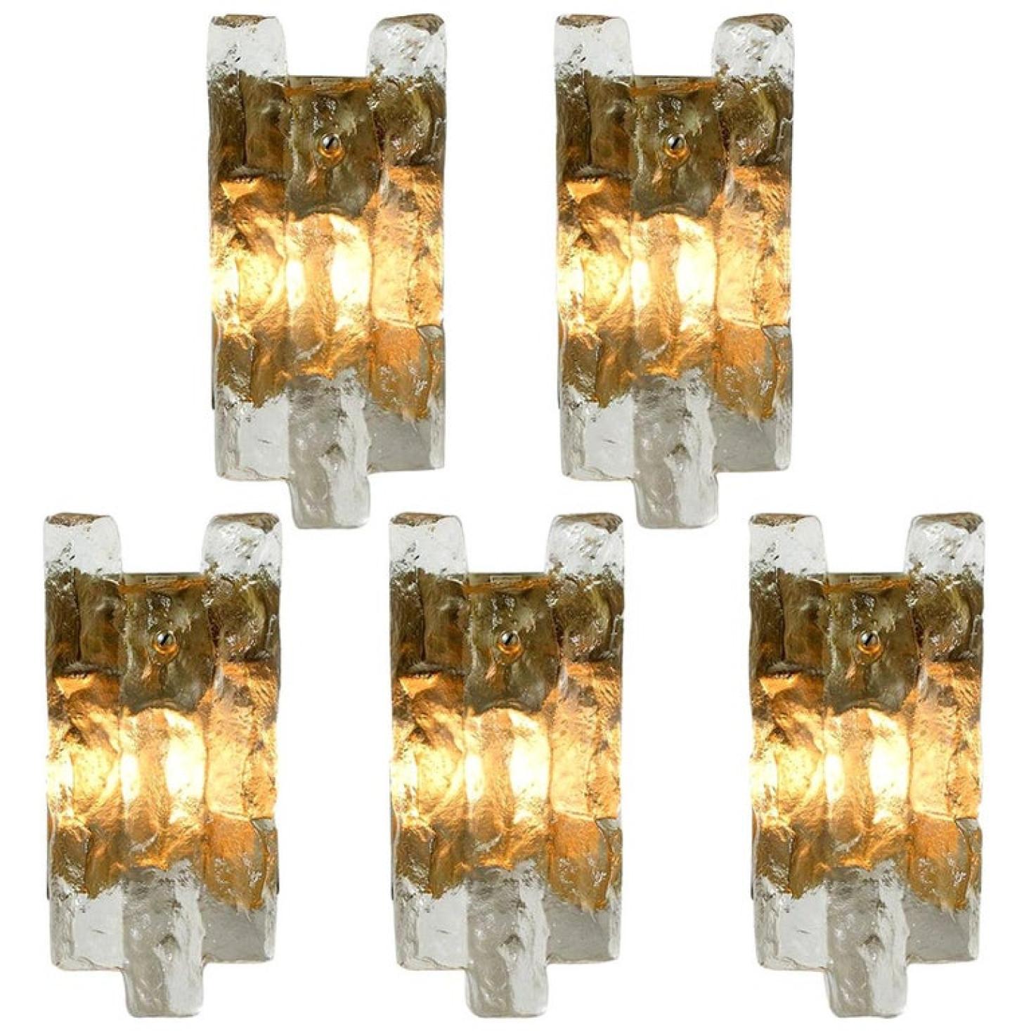 Set of beautiful and elegant modern brass wall lights/sconces, manufactured by J.T. Kalmar, Austria in the 1970s. Lovely design, executed to a very high standard. Each wall light has one solid ice glass sheets dangling on it. Clean lines to