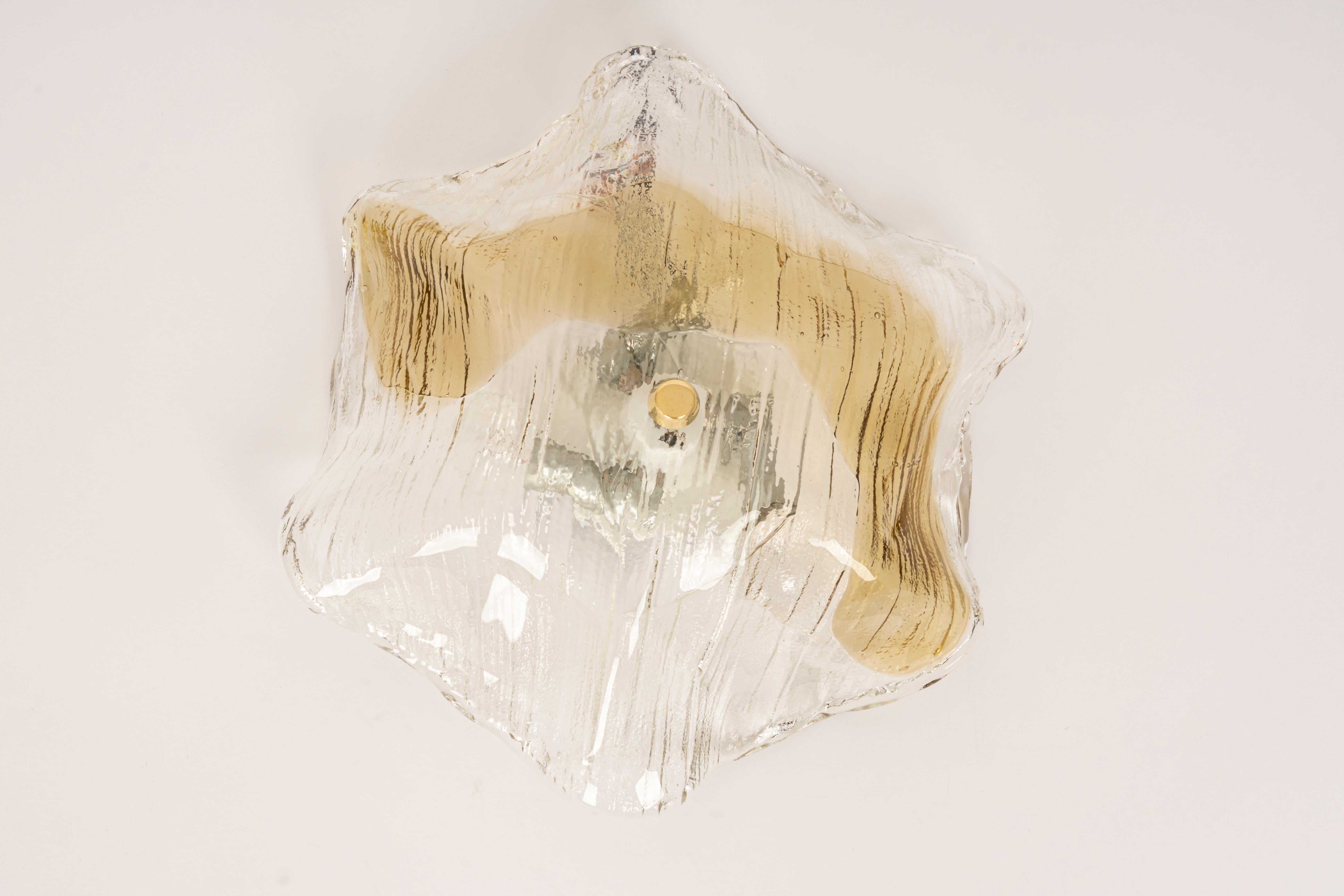 Large flush mount lights designed by Kalmar, Austria, 1970s
Wonderful large organic Murano glass / bi-colored clear and amber/smoked.
High quality and in very good condition. Cleaned, well-wired, and ready to use.
Model: Undine

The fixture requires