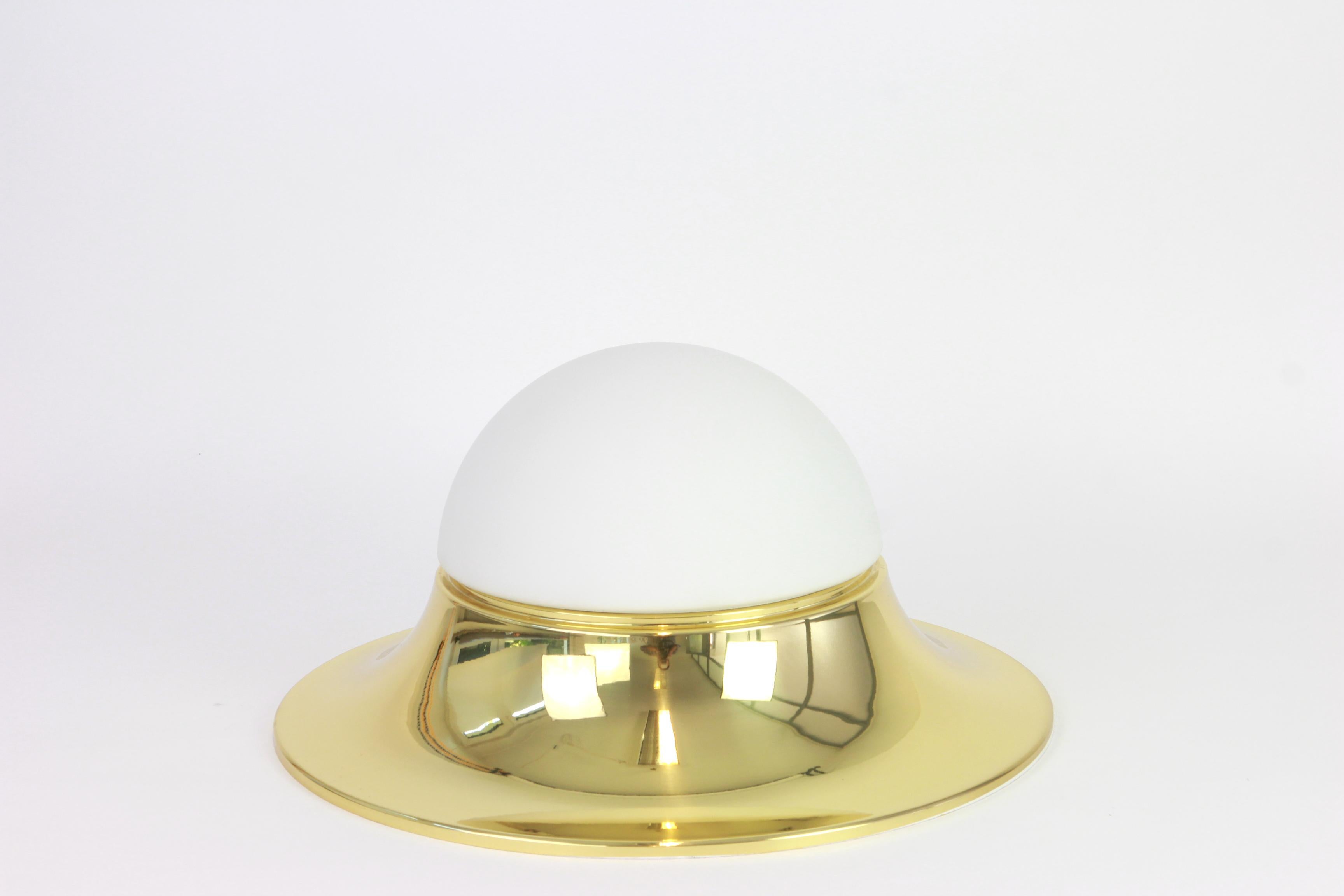 1 of 5 large UFO with brass frame and opal glass flush mounts Limburg, manufactured in Germany, circa 1970s.
High quality and in very good condition. Cleaned, well-wired and ready to use.
The fixture can be used as wall light or ceiling