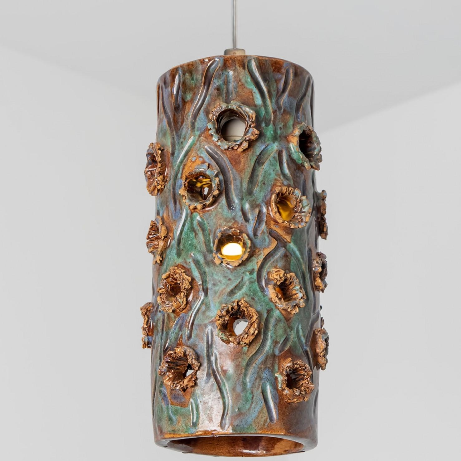 Playful arrangement of stunning round hanging lamps with an unusual shape, made with rich multicolored ceramics, manufactured in the 1970s in Denmark. We have a multitude of unique colored ceramic light sets and arrangements, all available in our
