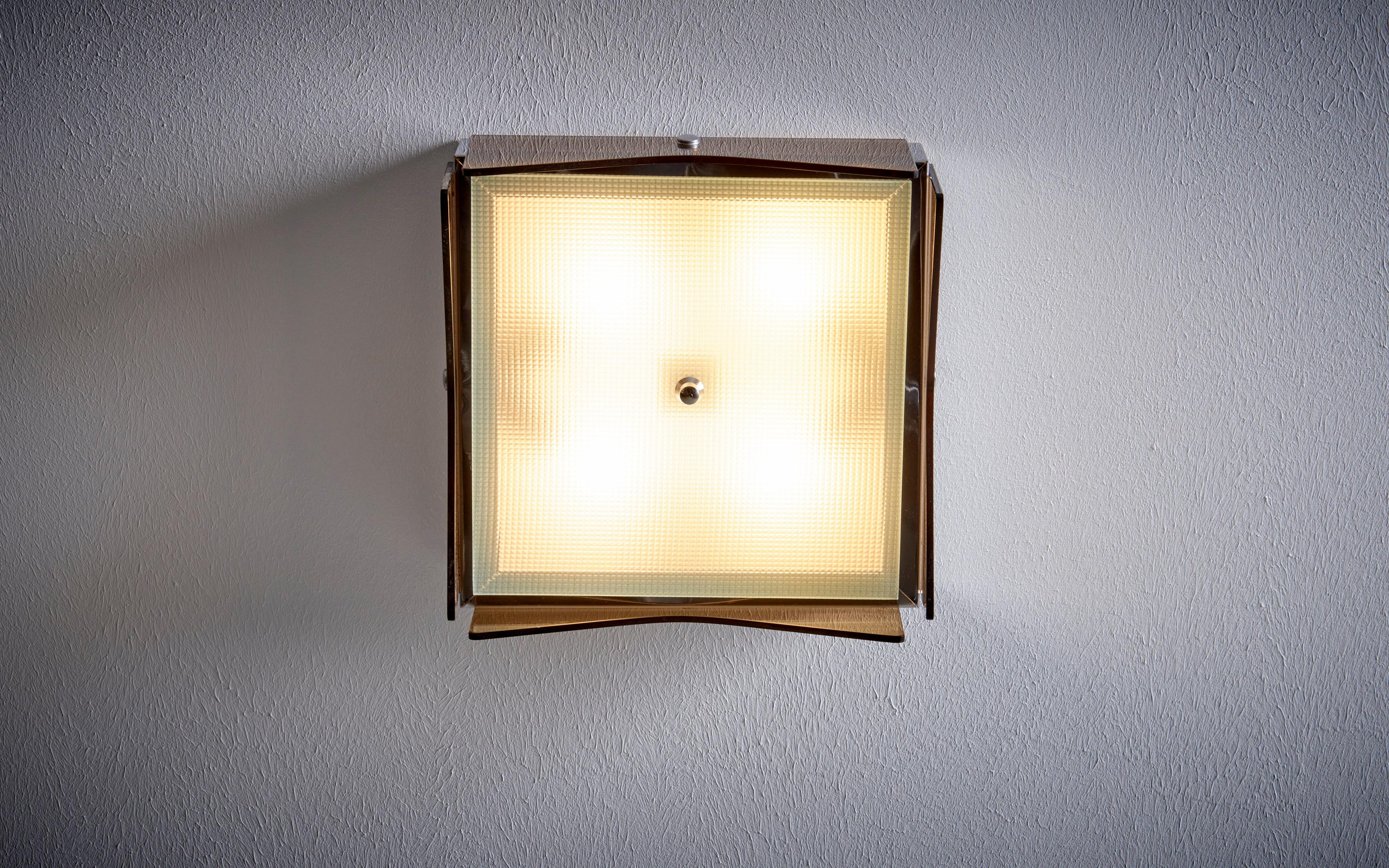 1960s Design Italian Wall Lamp nos in tinted brown glass. Price is per piece. We have two more listings with a flush mount of this type (one with a slightly different shape in tinted brown glass, one with clear glass).