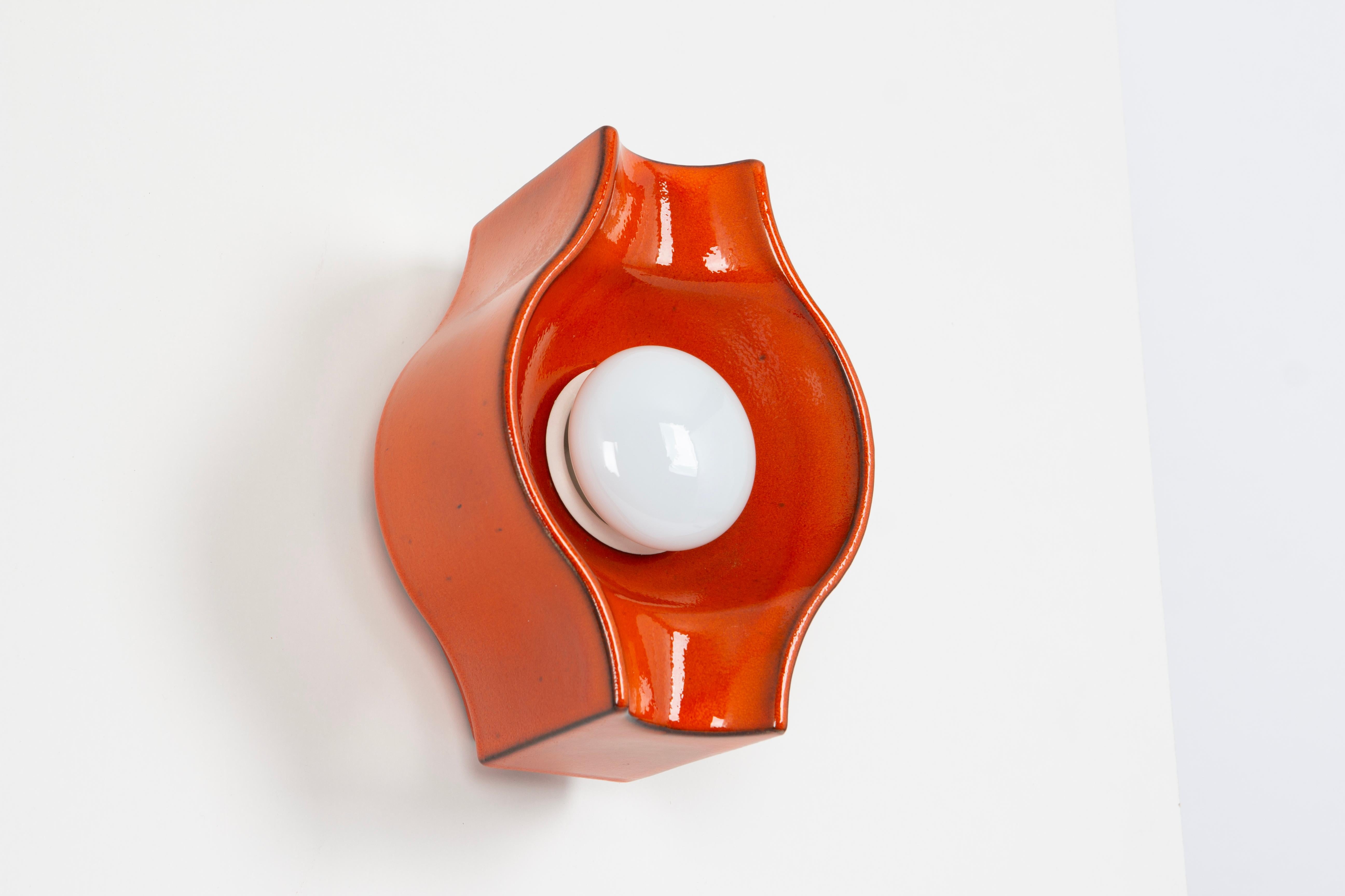 1 of 6 ceramic dark orange wall light Sputnik designed by Cari Zalloni Germany, 1970s

Heavy quality and in very good condition. Cleaned, well-wired, and ready to use. 

Each fixture requires 1 x E14 small bulb with 40W max each 
Light bulbs are not