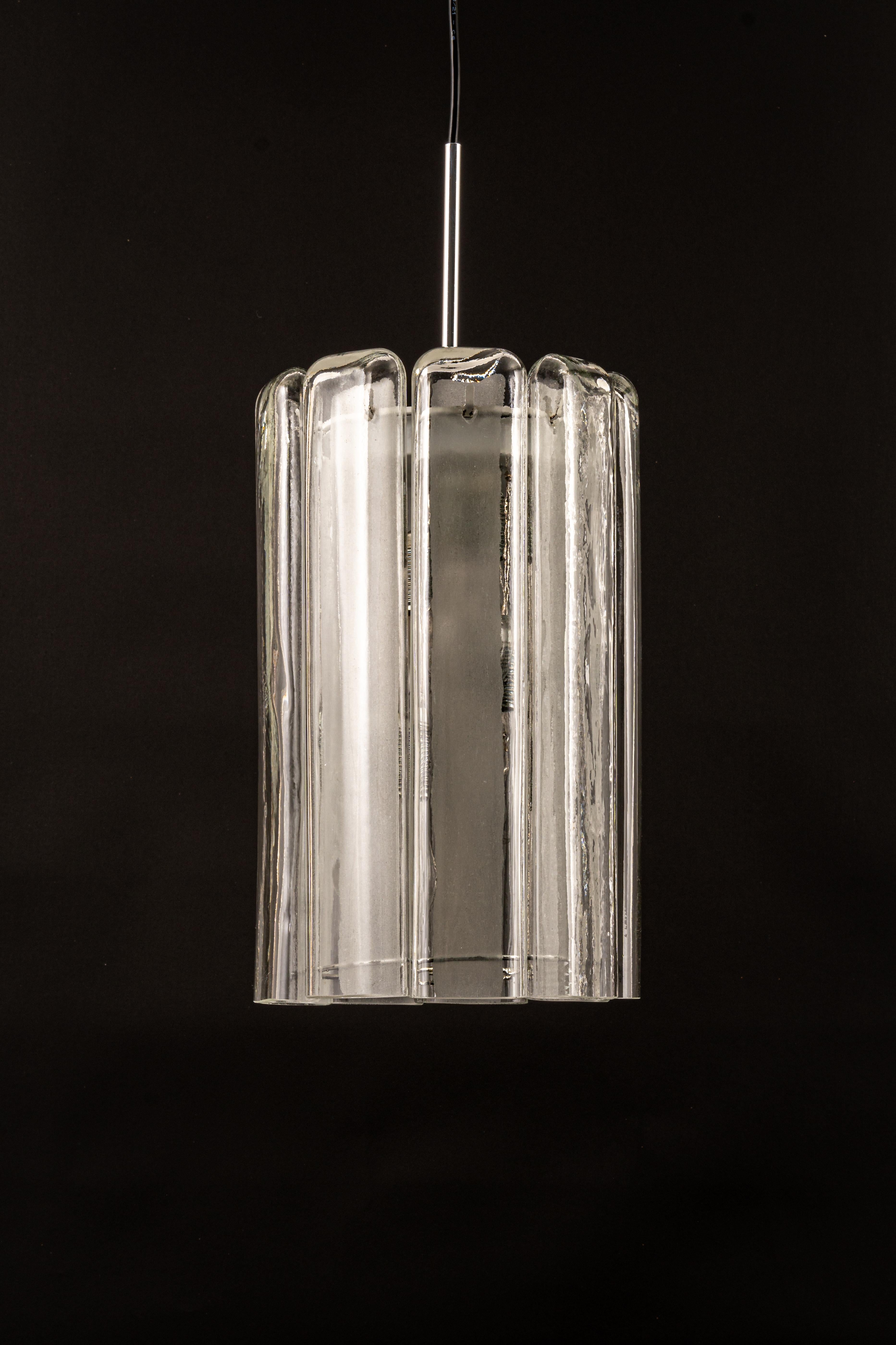 Fantastic cylindrical pendant fixture with crystal glass by Doria, Germany, manufactured, circa 1960-1969. 
Heavy quality and in good condition. Cleaned, well-wired and ready to use. 

The fixture requires 4 x E27 standard bulbs with 80W max for