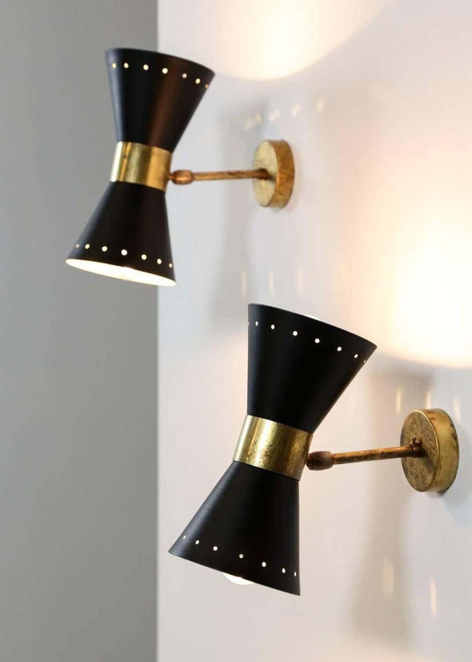 Rare set of gorgeous Italian design Diabolo wall lights of the 1950s in the style of Stilnovo
The patinated brass combines realy well with the black metal shades.
The wall lights have been rewired for daily use and look amazing.
Each wall light