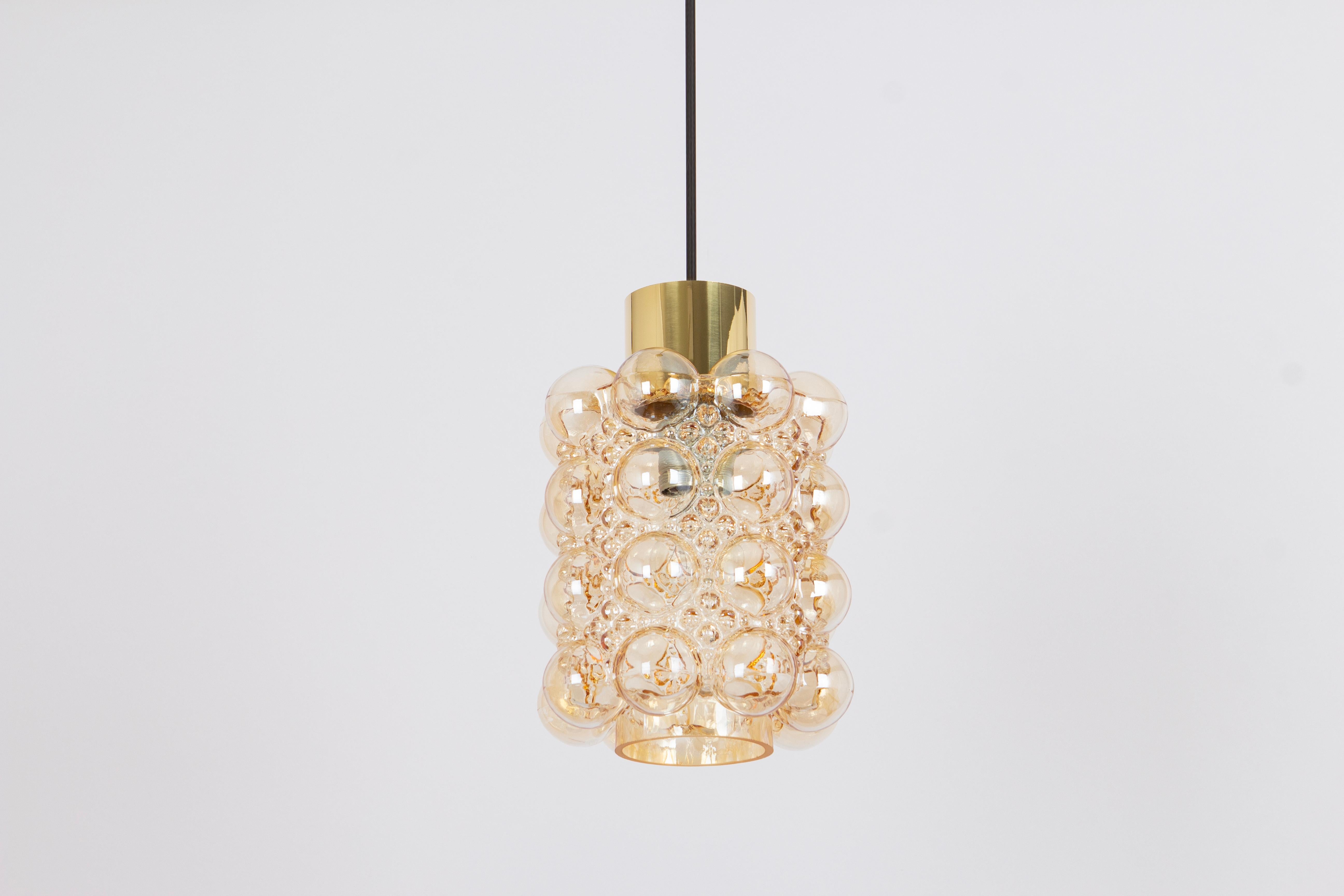 1 of 6 round smoke tone bubble glass pendant designed by Helena Tynell for Limburg, manufactured in Germany, circa 1970s.

Handcrafted with precision by skilled artisans at Limburg Lighting, this pendant light is a true testament to the brand's