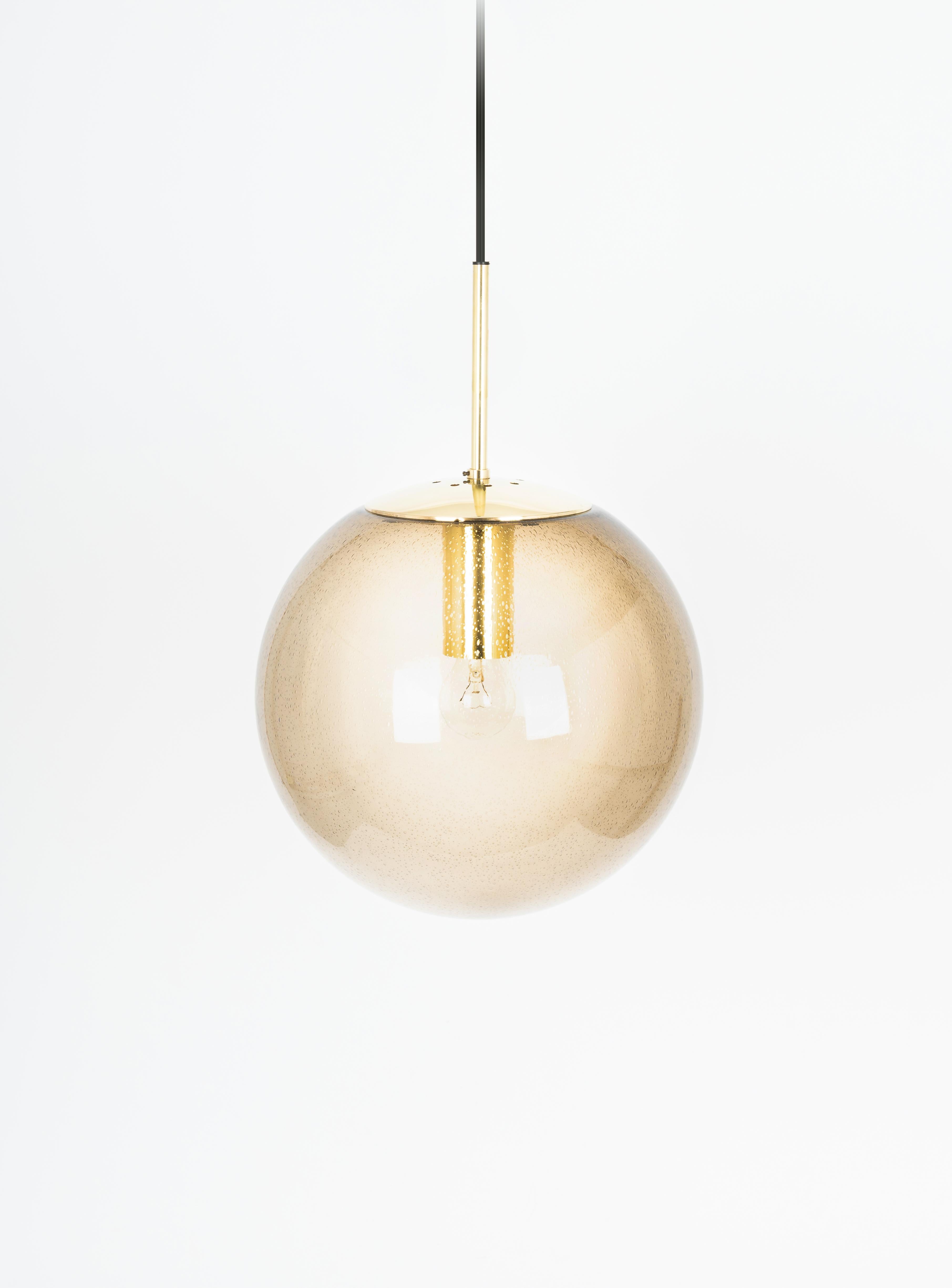 Large smoked glass ball pendant, manufactured by Limburg, Germany, circa 1970-1979.

Sockets: One x E27 standard bulb.
Light bulbs are not included. It is possible to install this fixture in all countries (US, UK, Europe, Asia, Australia.)
With