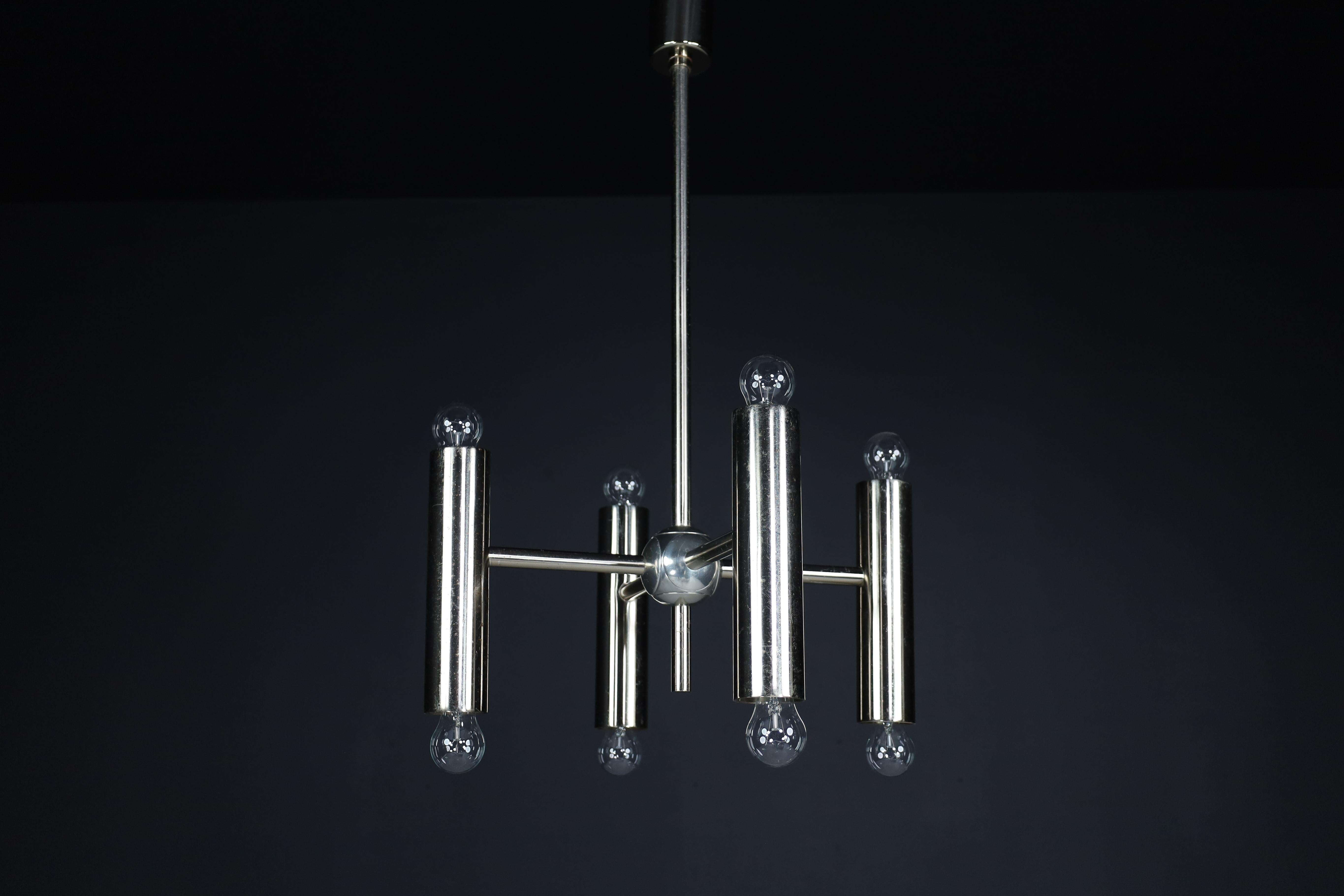 Large set Minimalistic Design Geometric chandeliers in Chrome, Germany, 1970s. 

An extensive set mid-Century Modernist chandeliers contain eight lights arranged symmetrically. The fixture of metal/steel with a minor patina. Therefore an