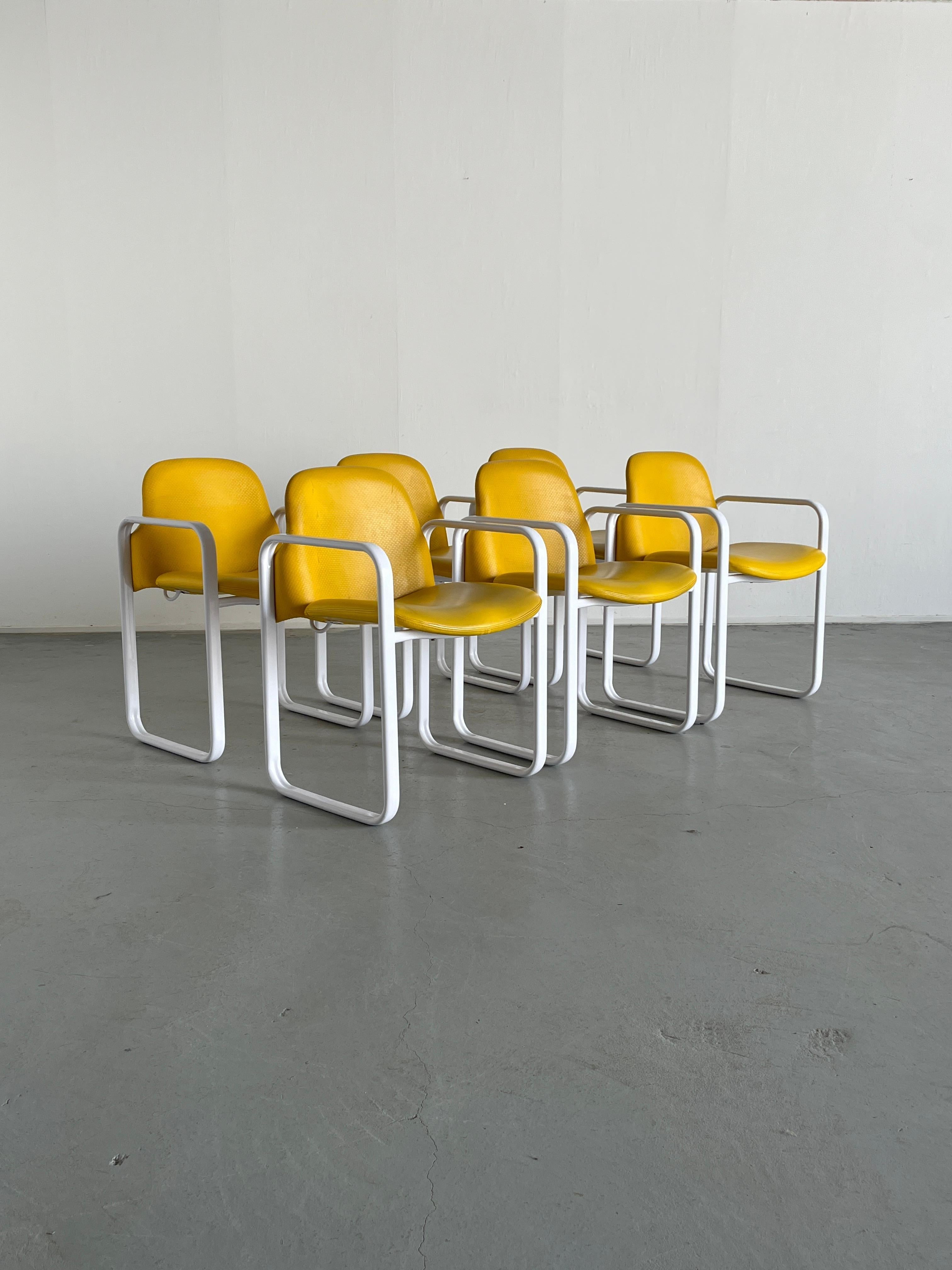Six vintage 1980s postmodern design armchairs, produced by Thema Italy.
White metal structure and yellow faux leather upholstery. Backside faux leather has a pattern while the seating one is smooth.
Reminiscent of Orsay chairs by Gae Aulenti for