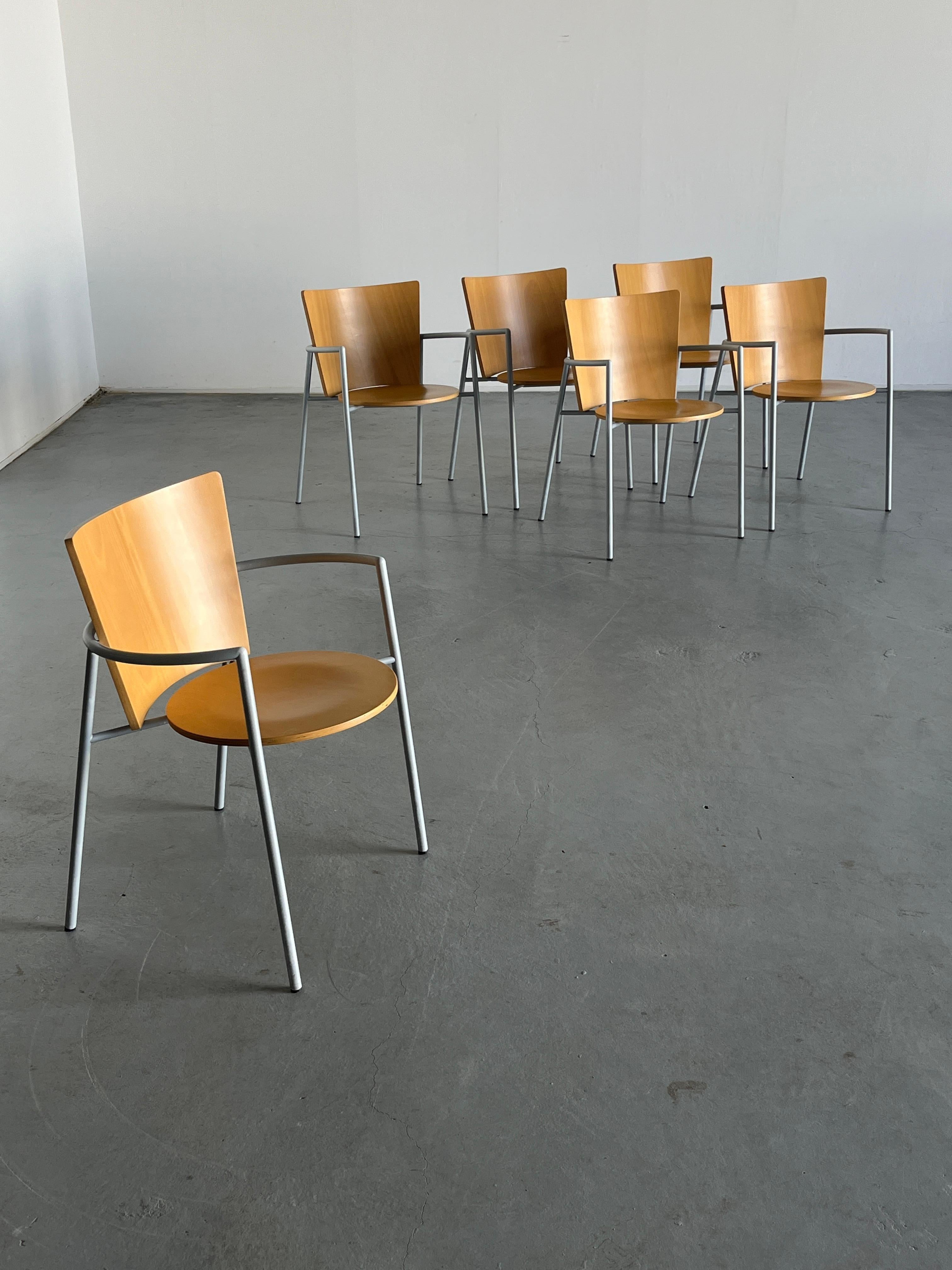 Vintage postmodern armchairs produced in Italy in the 1990s. Composed of a circular wooden seat, rectangular wooden backrest and a bent metal frame which also serves as armrest. 

Chairs are in very good vintage condition with some expected signs of