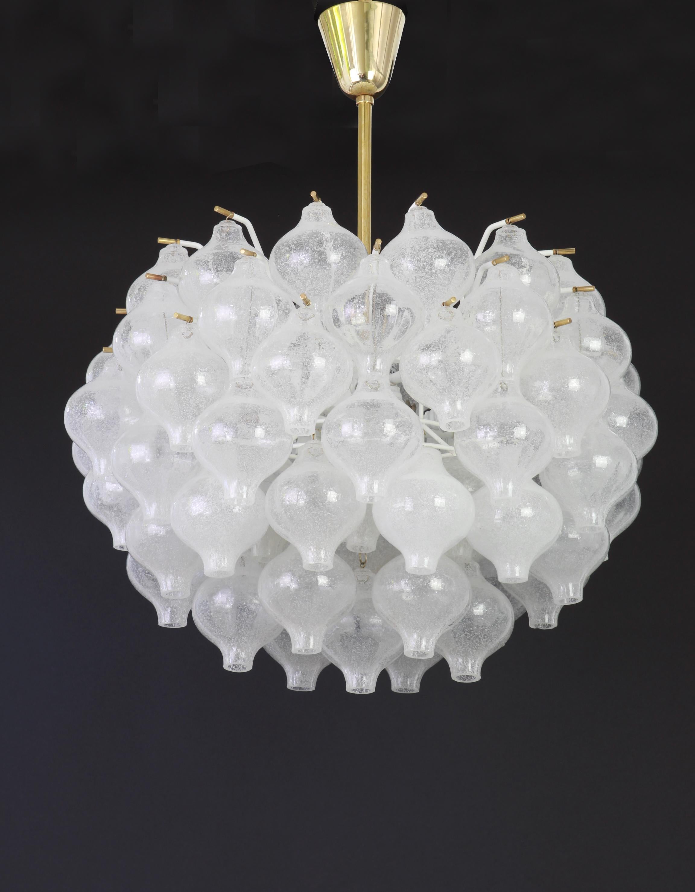 Wonderful onion shaped -Tulipan glass chandelier. 73 hand blown glasses suspended on white painted metal frame and brass center rod.
Best of design from the 1960s by Kalmar, Austria. High quality of the materials.

Sockets: 12 x E14/ or E12