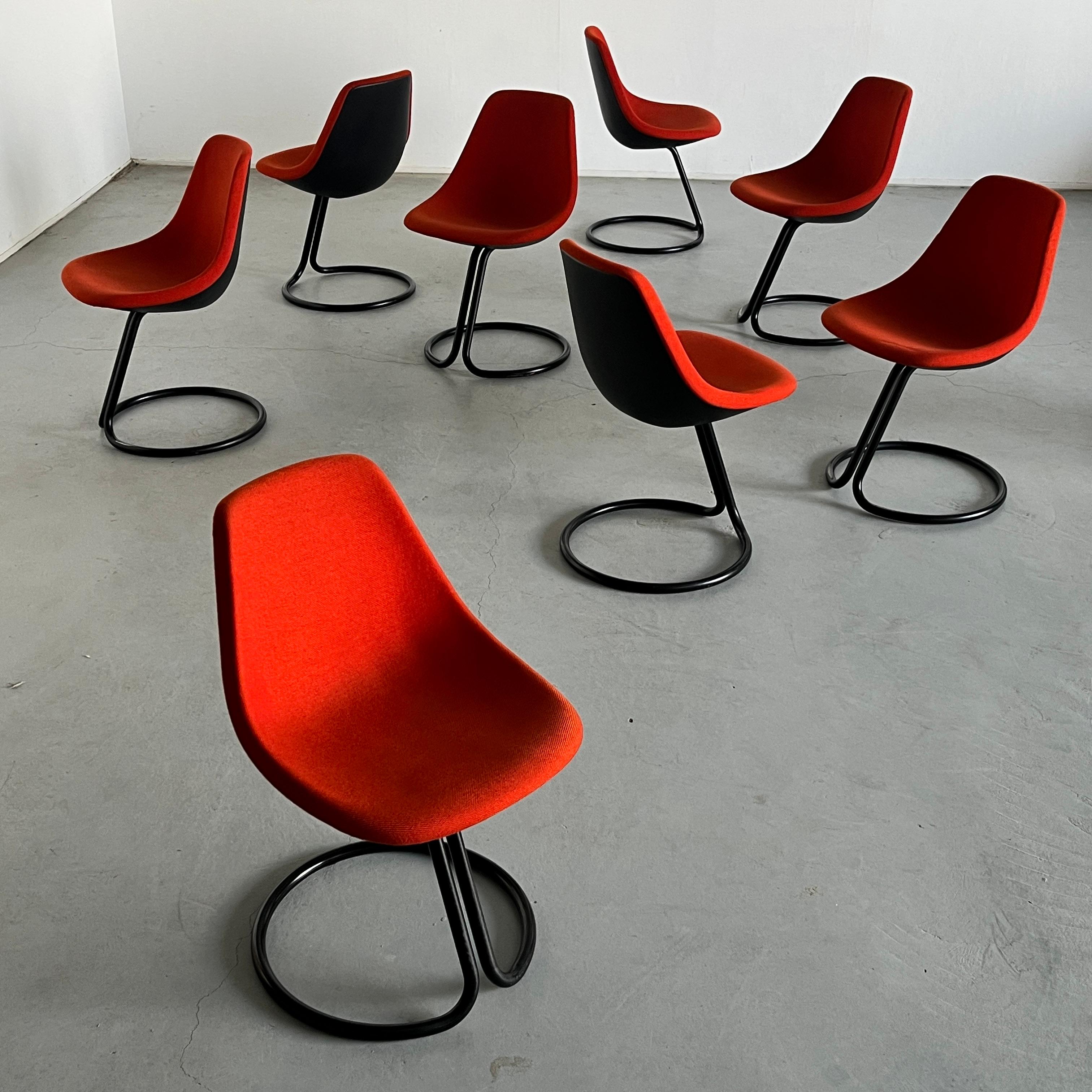 One of nine vintage postmodern dining chairs by famed Italian designer Giotto Stoppino. Comprised of red fabric upholstery over a black polyurethane seat with a single black metal piece extruding from it and forming a circular base at the