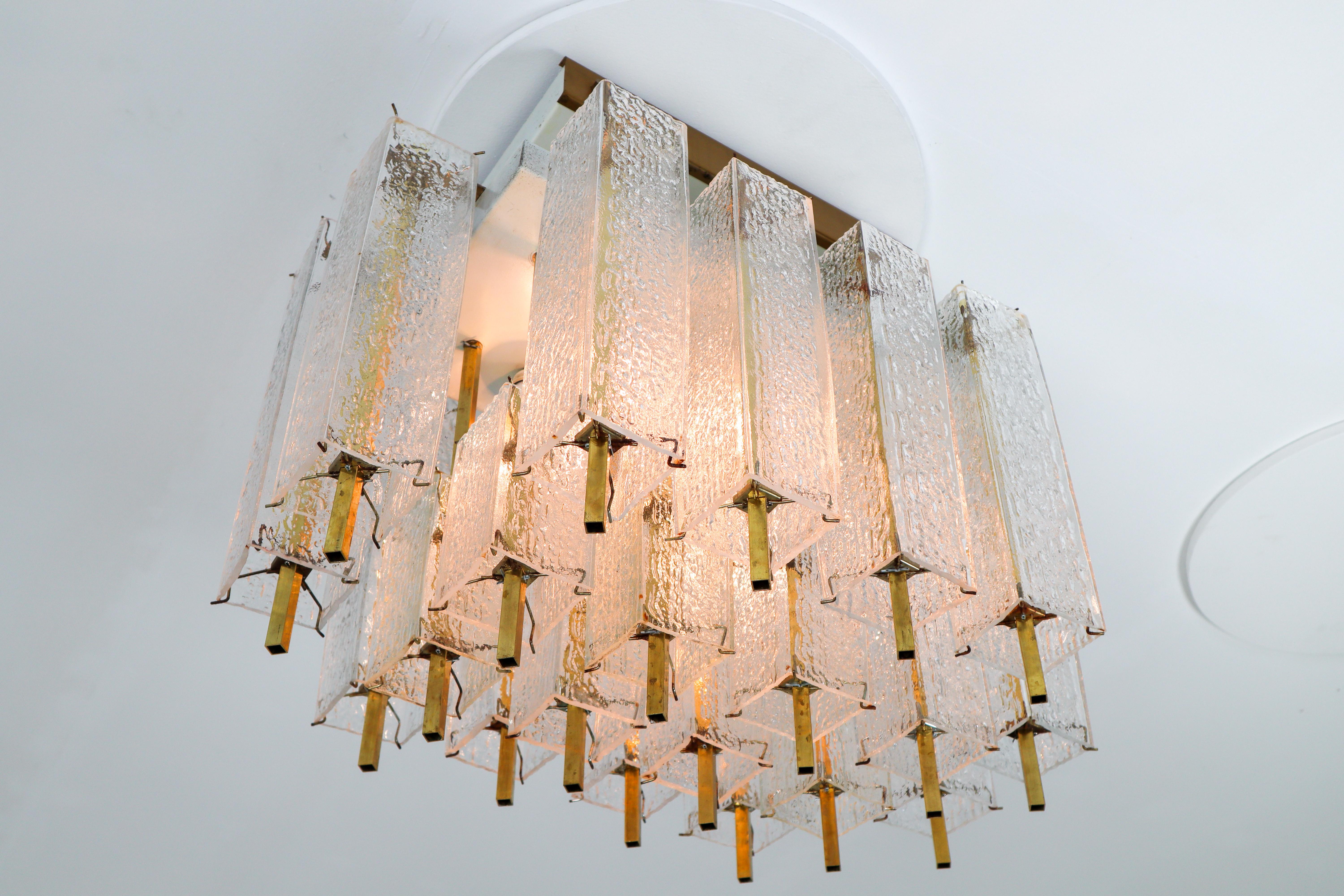 Large flush mount - chandelier, in glass and brass, Europe 1960s. 

Outstanding and high-quality flush mount chandelier made in Europe was manufactured circa the 1960s. The chandelier has seven (E27) sockets and holds multiple structured glass