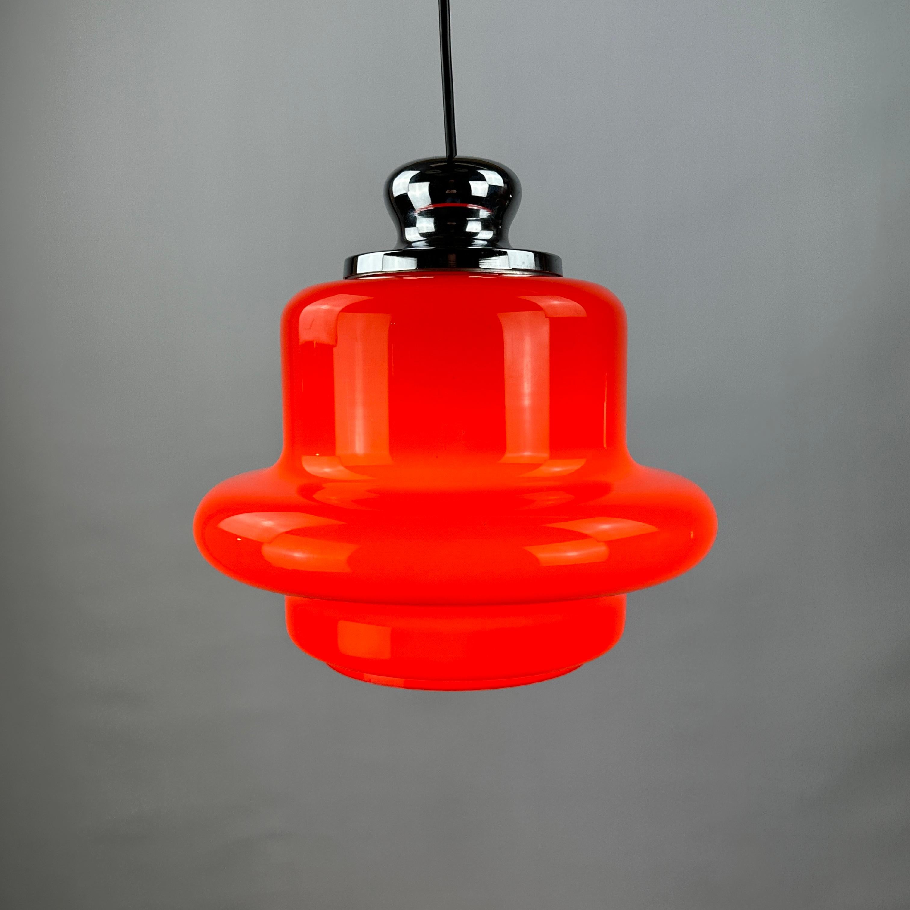 This stunning piece of German craftsmanship is by Hustadt Leuchten made around 1960. The lamp is made from opaline glass, has a ufo shape and lights up very cool. The top is made from aluminium. 

The light will fill your space with a vibrant,