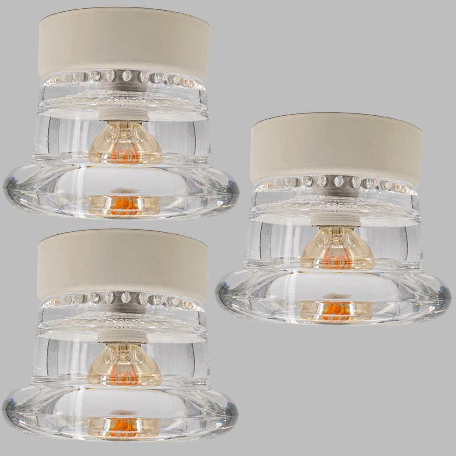 Several glass wall sconces or flush mounts by Cosack Leuchten. This light was designed and produced by Cosack Leuchten, one of the premium light producers is the 1960s and 1970s in Germany, Europe. The lights are made of thick round glass.

Please