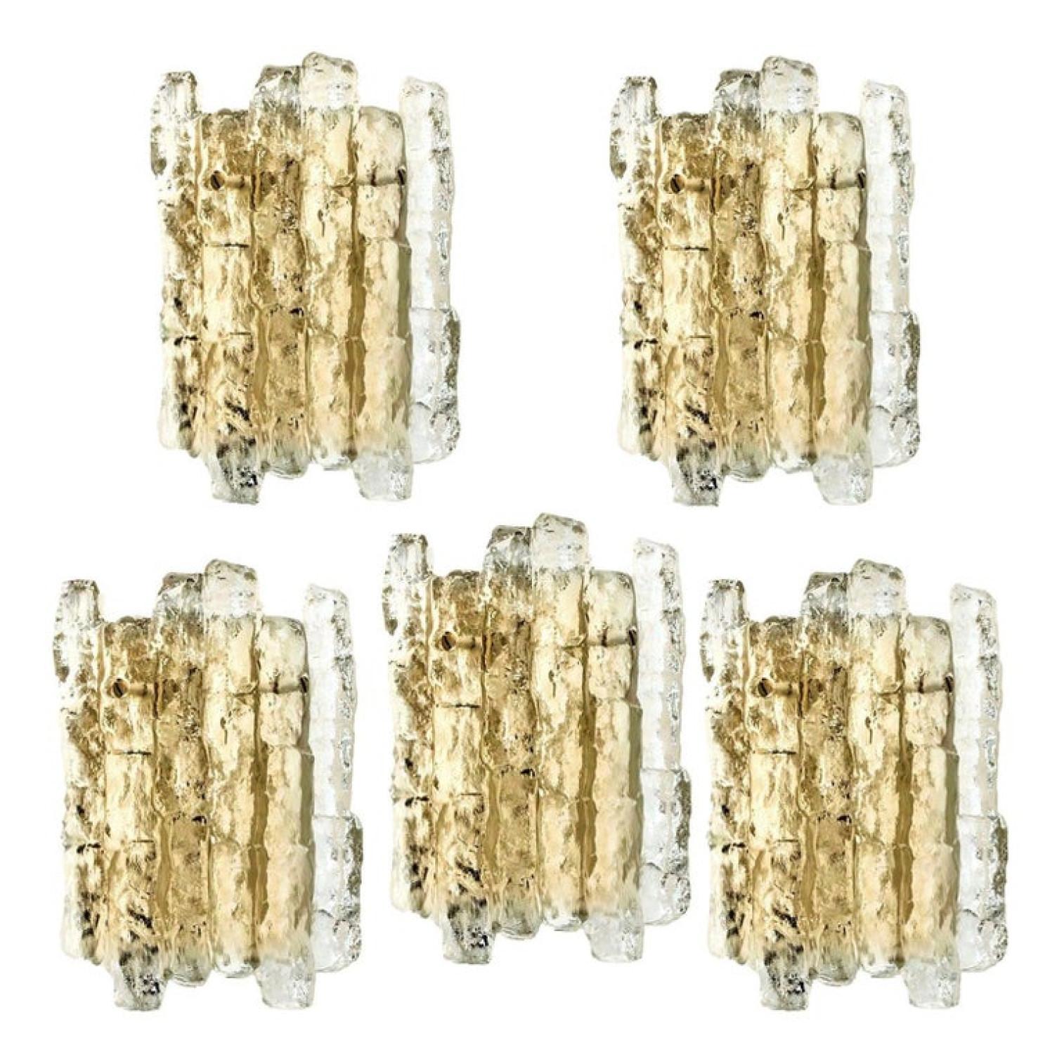 One of the ten beautiful and elegant modern brass wall lights or sconces, manufactured by J.T. Kalmar Austria in the 1970s. Lovely design, executed to a very high standard.

Each wall light has two solid ice glass sheets dangling on it. Clean