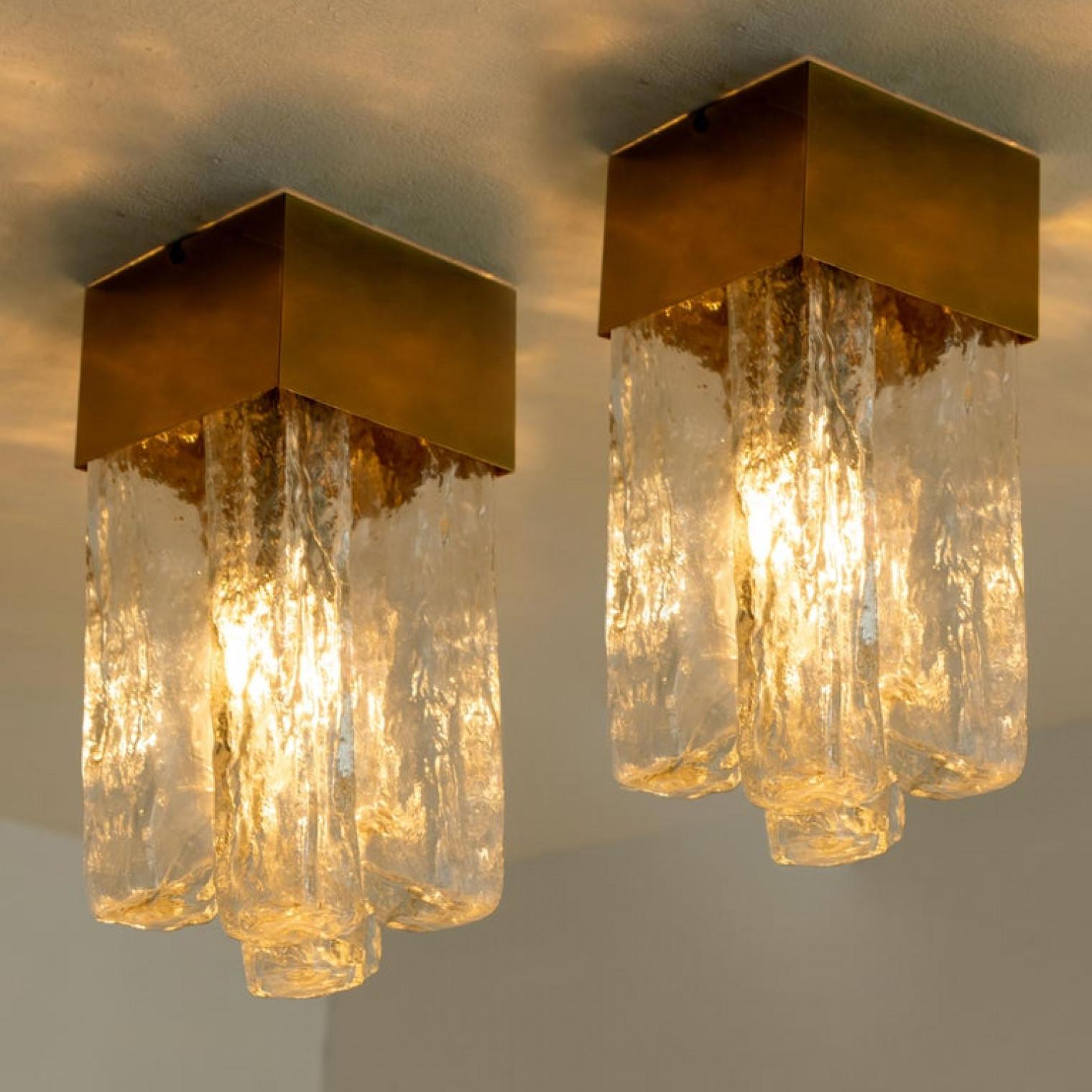 1 of the 10 flush lights with Brutalist ice glass on a brass frame, circa 1970s, by J.T. Kalmar. Cruciform design flush mount light with structured glass shade and a central brass square column. The crystals refract light beautifully and are perfect
