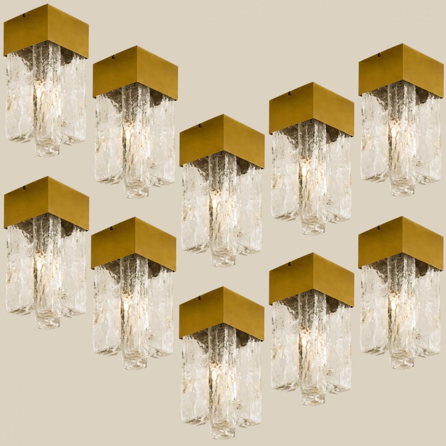 1 of the 10 flush lights with Brutalist ice glass on a brass frame, circa 1970s, by J.T. Kalmar. Cruciform design flush mount light with structured glass shade and a central brass square column. The crystals refract light beautifully and are perfect