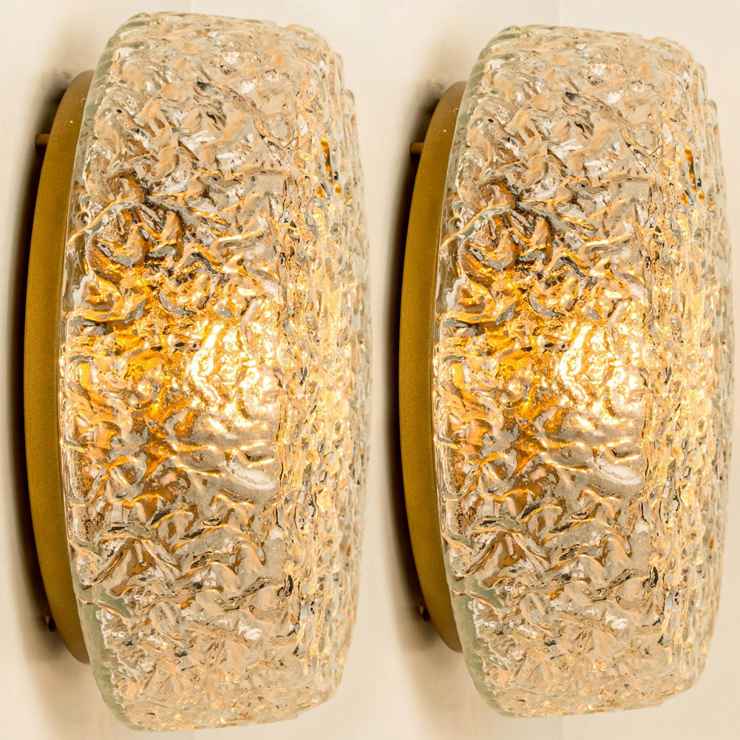 Clear colored textured glass wall light designed in the style of Glashütte Limburg around 1960-1970 in Europe, Germany. The rich textured glass gives a wonderful glow. There are multiple similarly designed lights available, please check the website